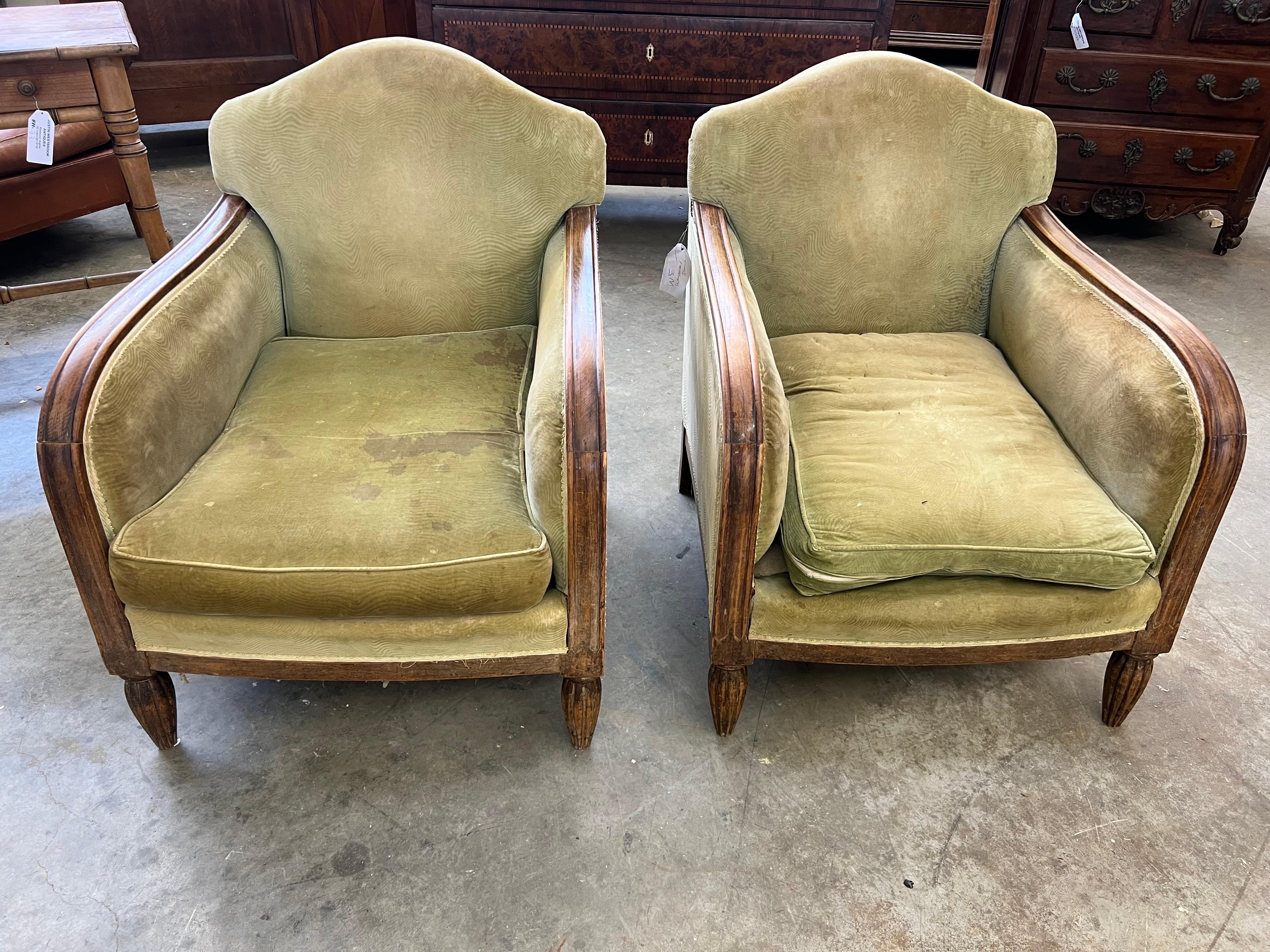 Nice lines and form on this pair of French art deco period club chairs. Nice deep, comfortable seats with original loose cushions. Walnut throughout.