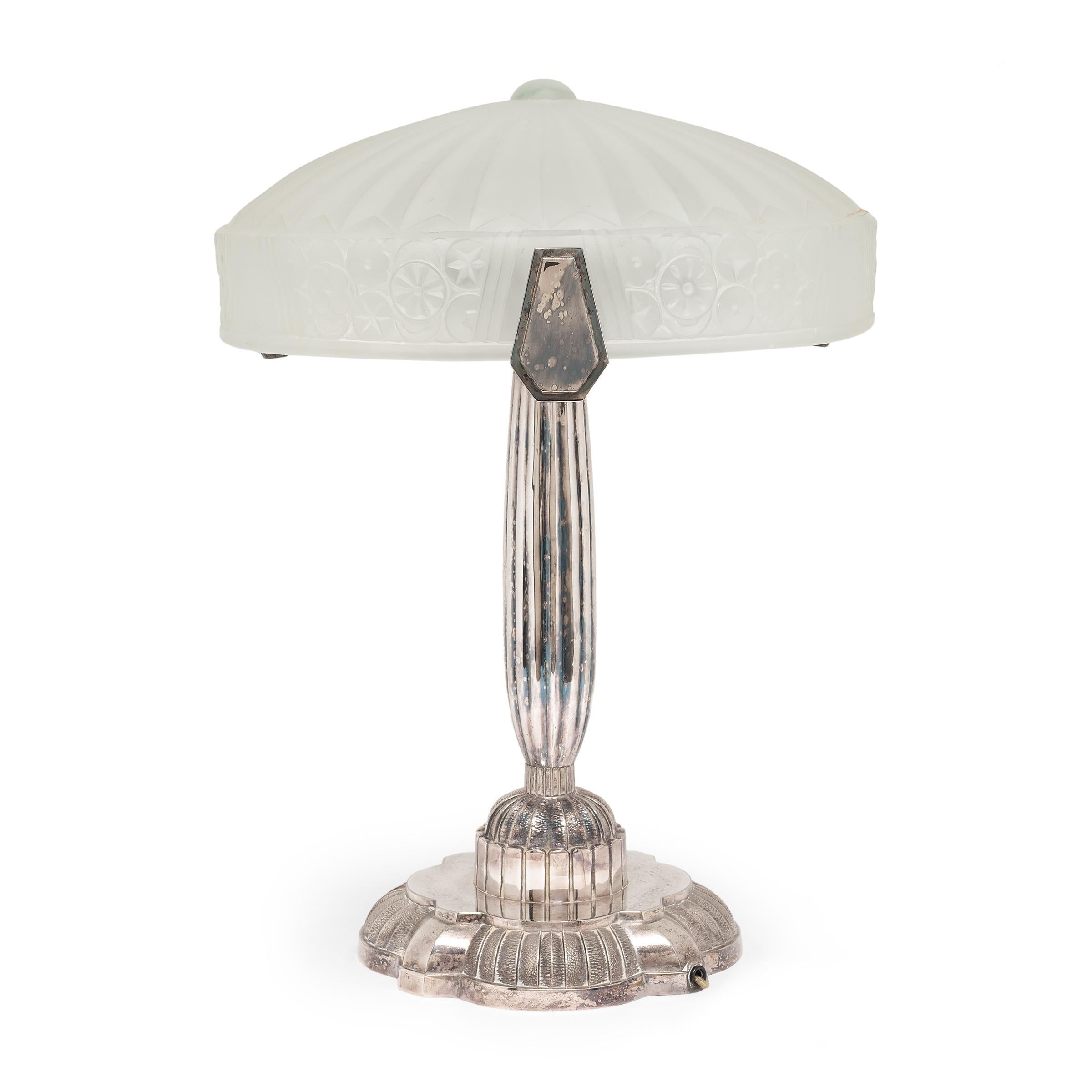 These frosted glass table lamps are mid-century reproductions of the elaborate French Art Deco light fixtures of the early 20th century. Embossed with the Crazy Queen trademark, the chic lamps recreate the Art Deco style with plated metal bodies and