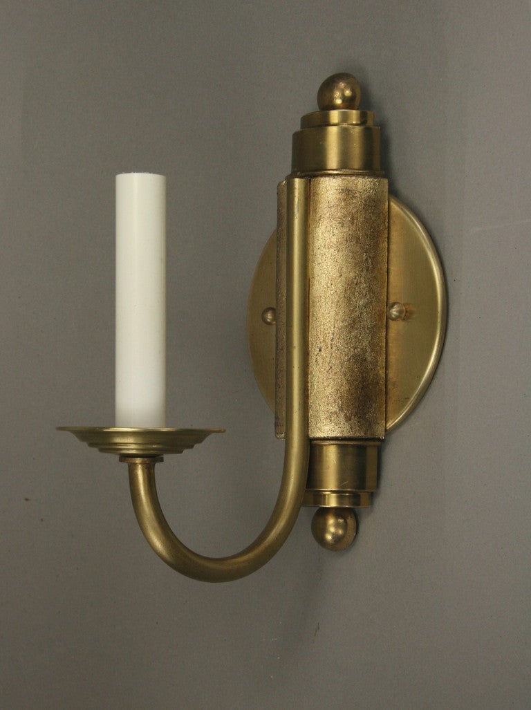 1=4066a pair of French wood and brass single arm sconce.
The wood center has a gold leaf finish.
 