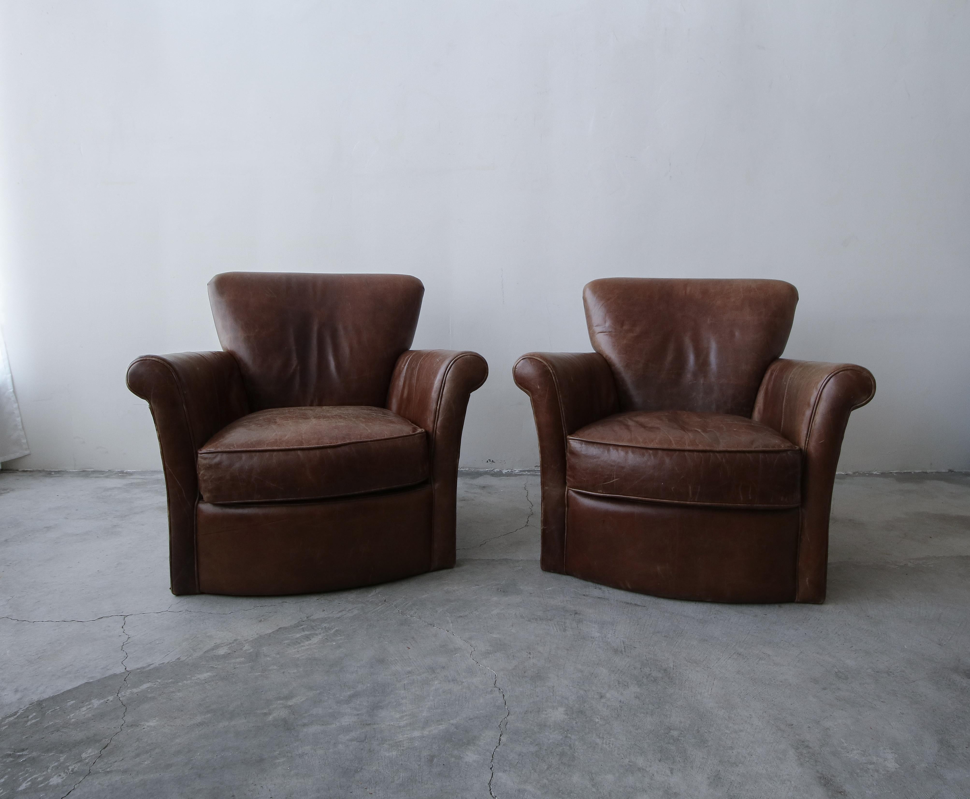 A beautiful pair of properly patinaed leather club chairs. This pair is the epitome of perfect worn leather chairs. Chairs feature the kind of patina that money can't buy, the kind that only comes with use over years. If you've been looking for a
