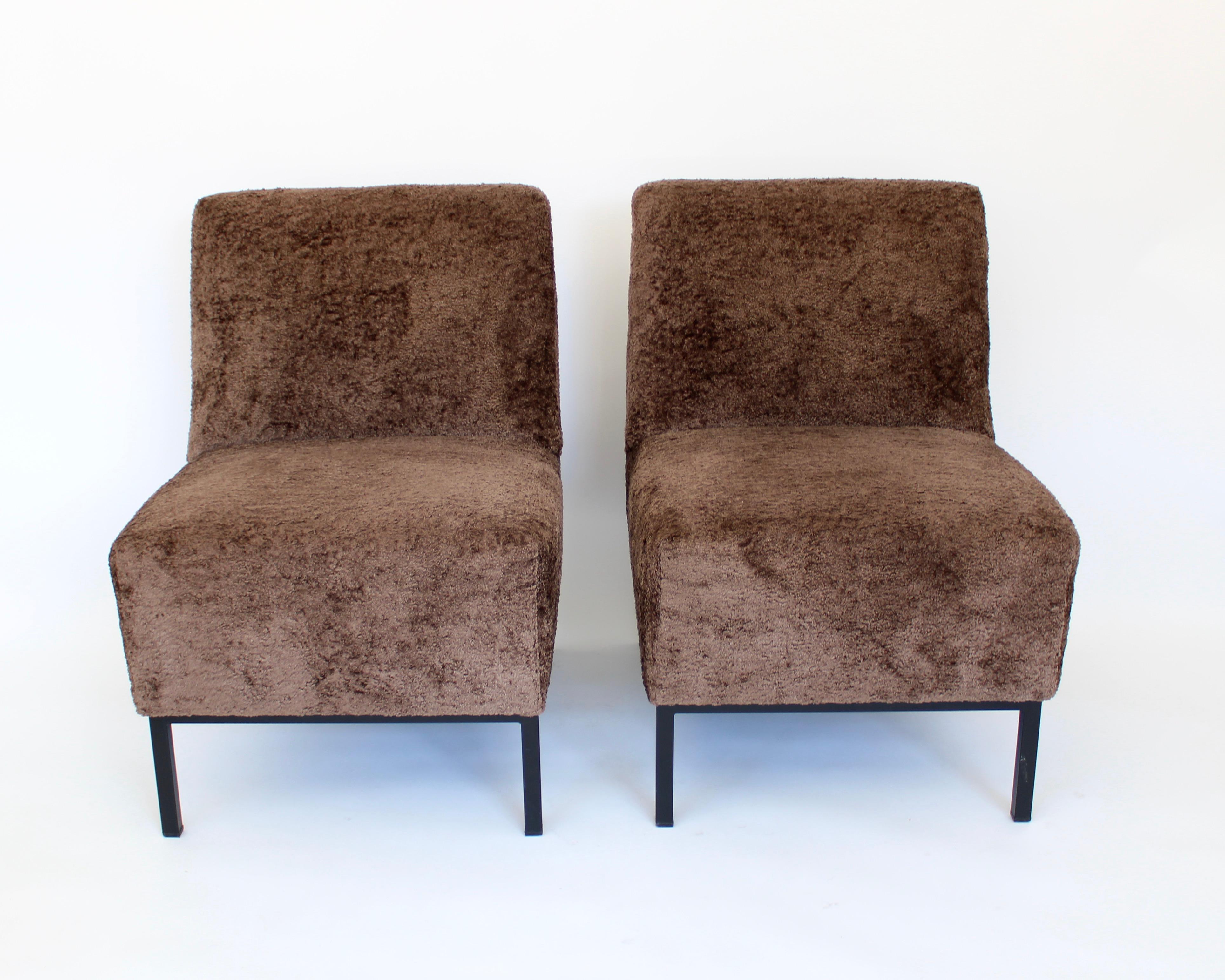 Pair of French upholstered lounge chairs by designer Alain Richard, France c 1960. 
Oversized cushions upholstered in a warm brown textured velvet but not chenille. 
This upholstery is from the 1980's. 
Modernist and rationalist design typical of