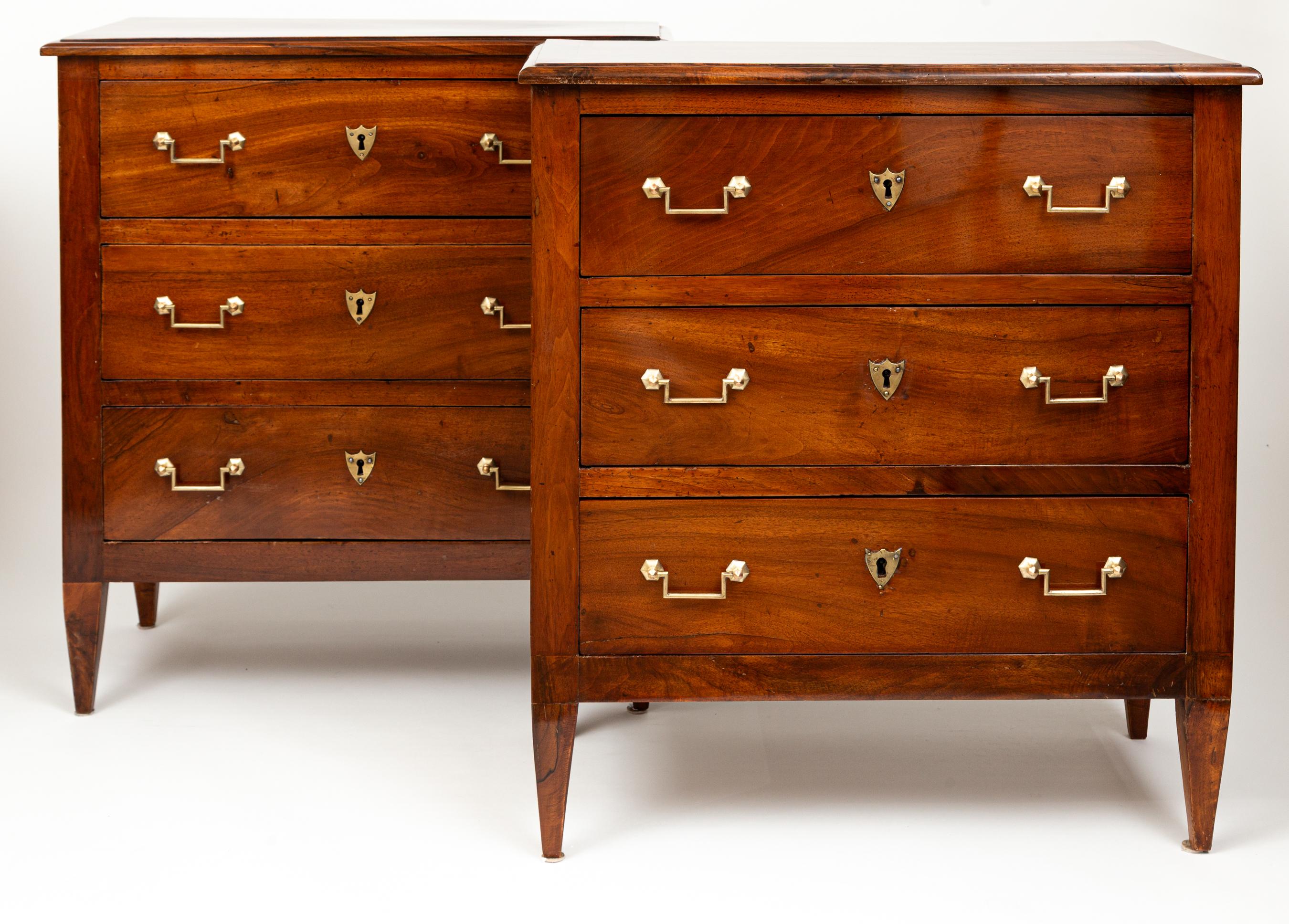 A beautiful pair of Directoire  chests in solid walnut and comprised of three drawers with brass angular handles and shield-shaped escutcheons, finishing on straight, squared and tapered legs

Dating:1810ca
Origin: France
Condition: Excellent