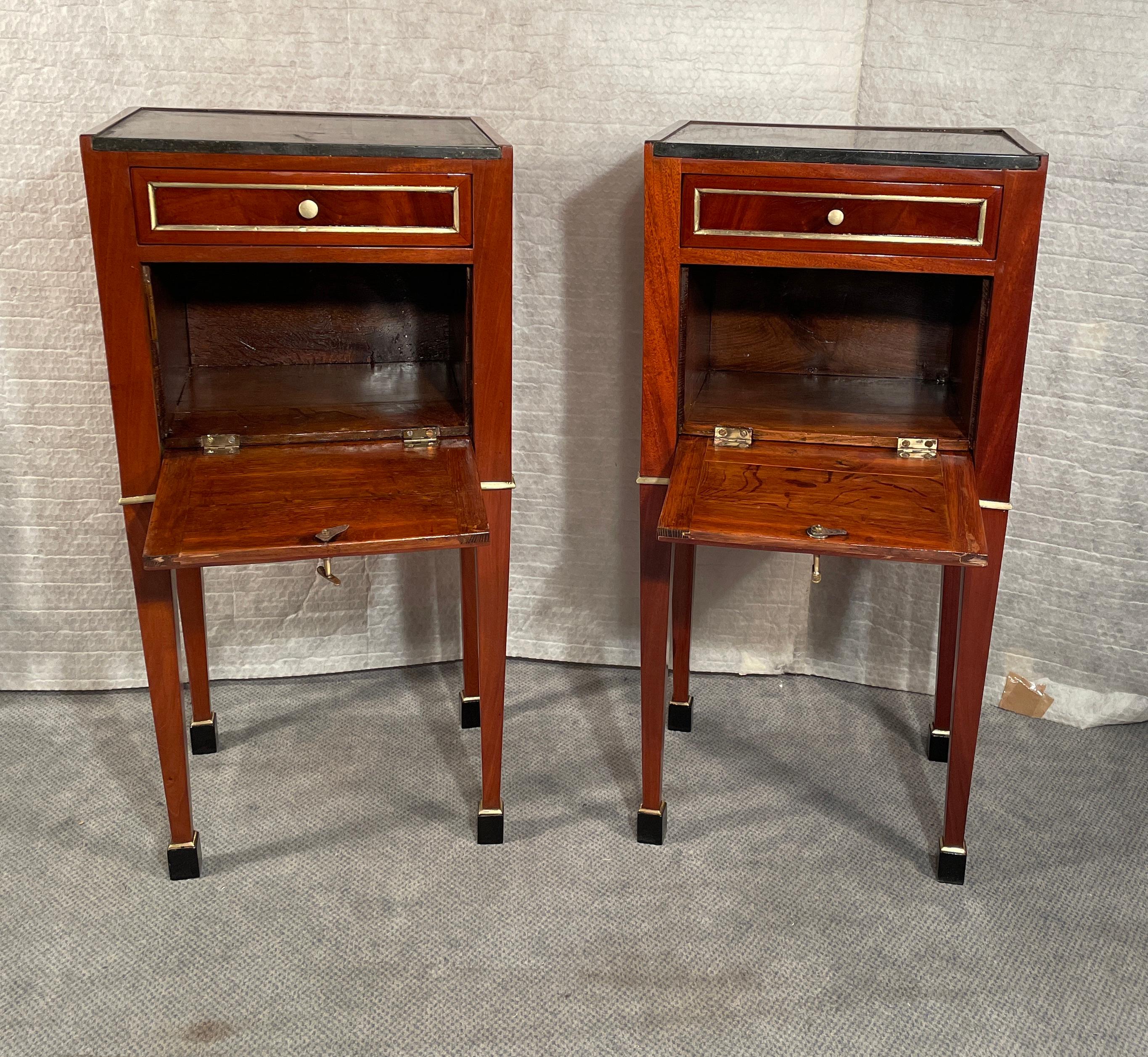 Pair of French Nightstands, Directoire Period 1780-1800

Step into a world of elegance and history with this remarkable pair of nightstands, hailing from France and dating back to the Directoire period 1780-1800.
These exquisite side tables exude