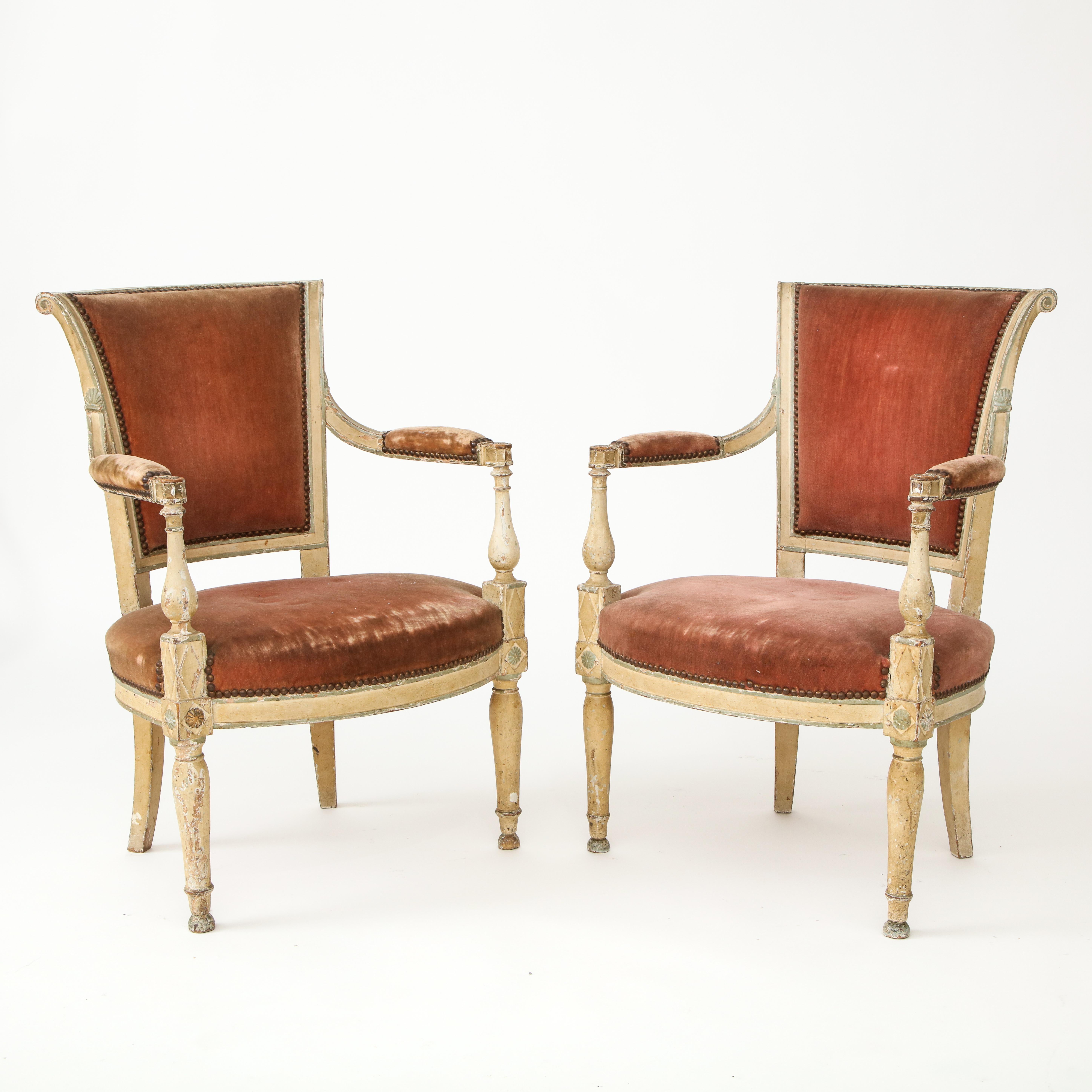 Handsome pair of Directoire style chairs. Marked by interesting details and heavy patina. 

The chairs have not been modified, they are of their original condition and they are structurally stable.