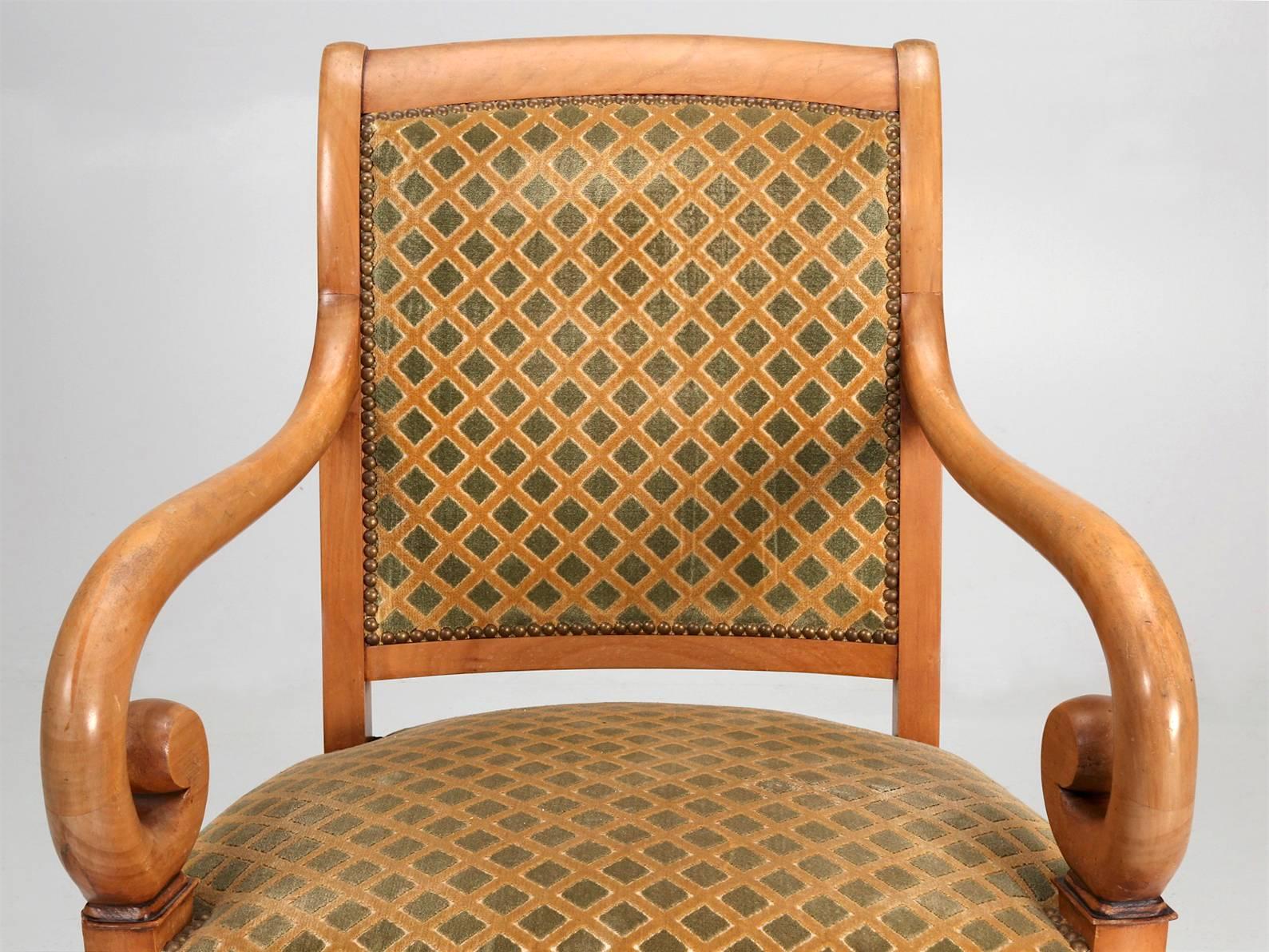Pair of French Directoire style armchairs in an older fabric. We are offering these Directoire style arm chairs in their original condition and should you like, we can have our in house, Old Plank upholstery department, supply you with a quote for