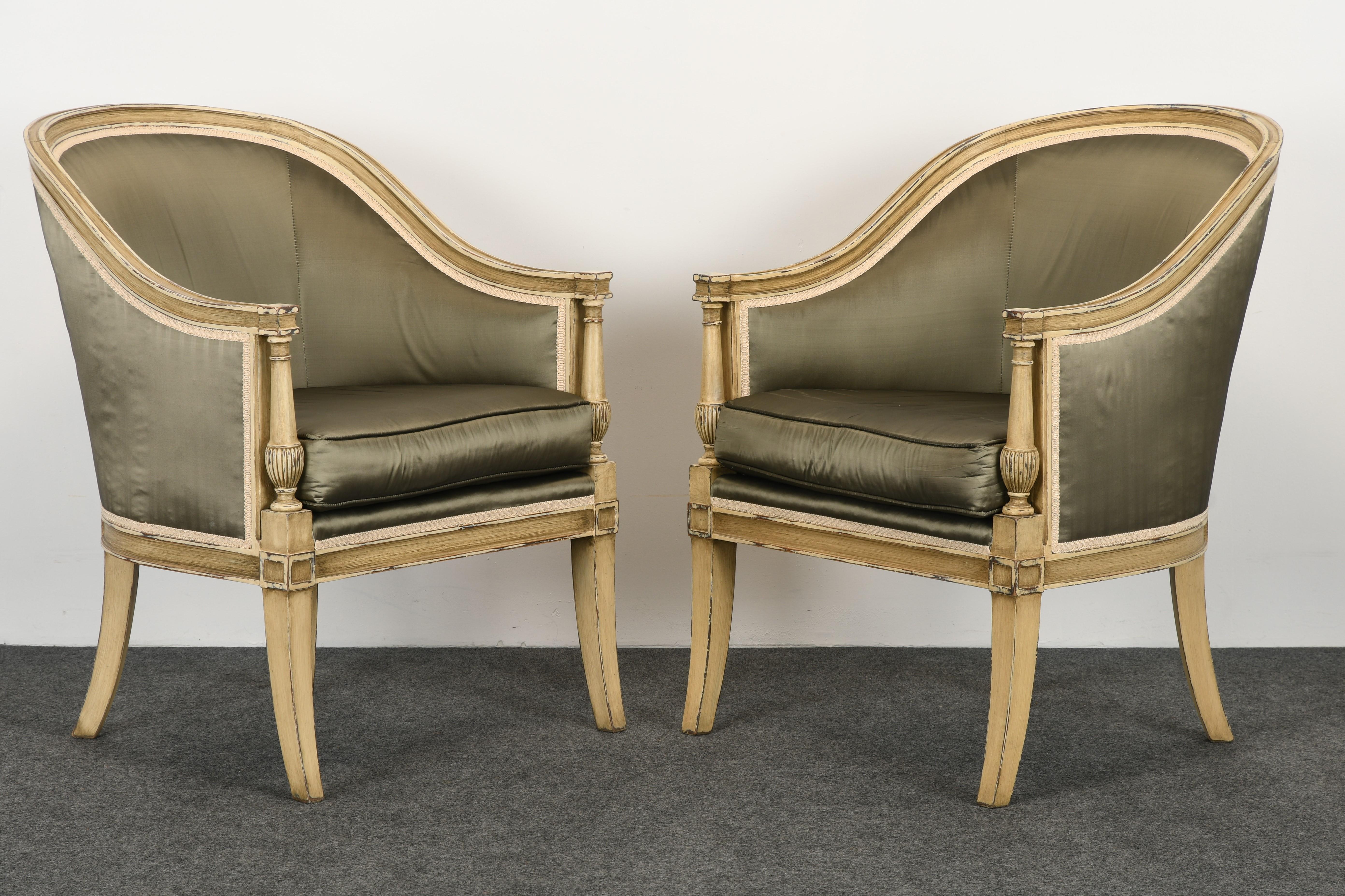 A beautiful large-scale pair of Gustavian painted barrel back chairs in the manner of Nierman Weeks. This stunning pair of Klismos style armchairs have a pleasing distressed finish with a Directoire decorative arm. These chairs are sturdy and