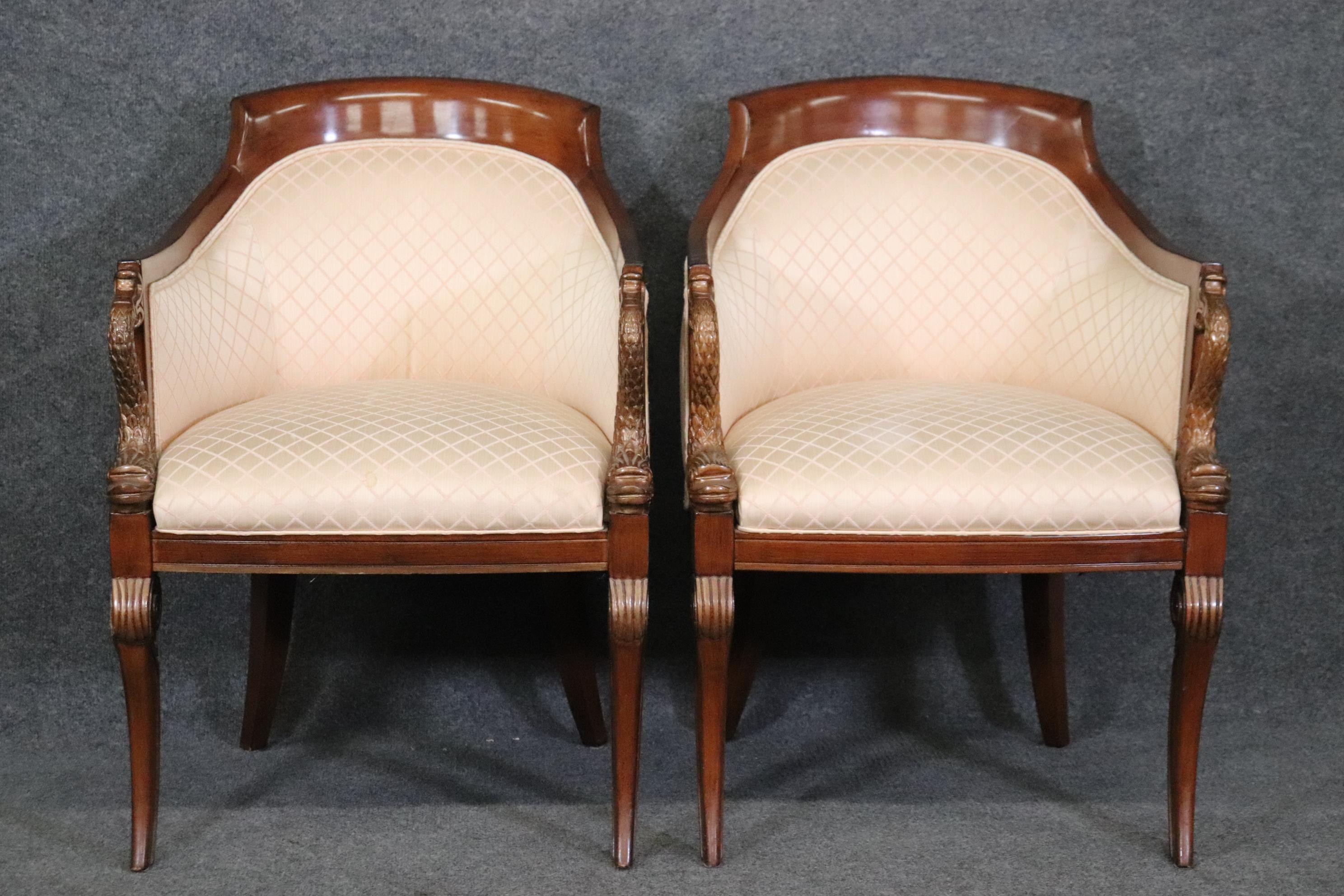 This is a gorgeous pair of club chairs in solid mahogany with carved 
