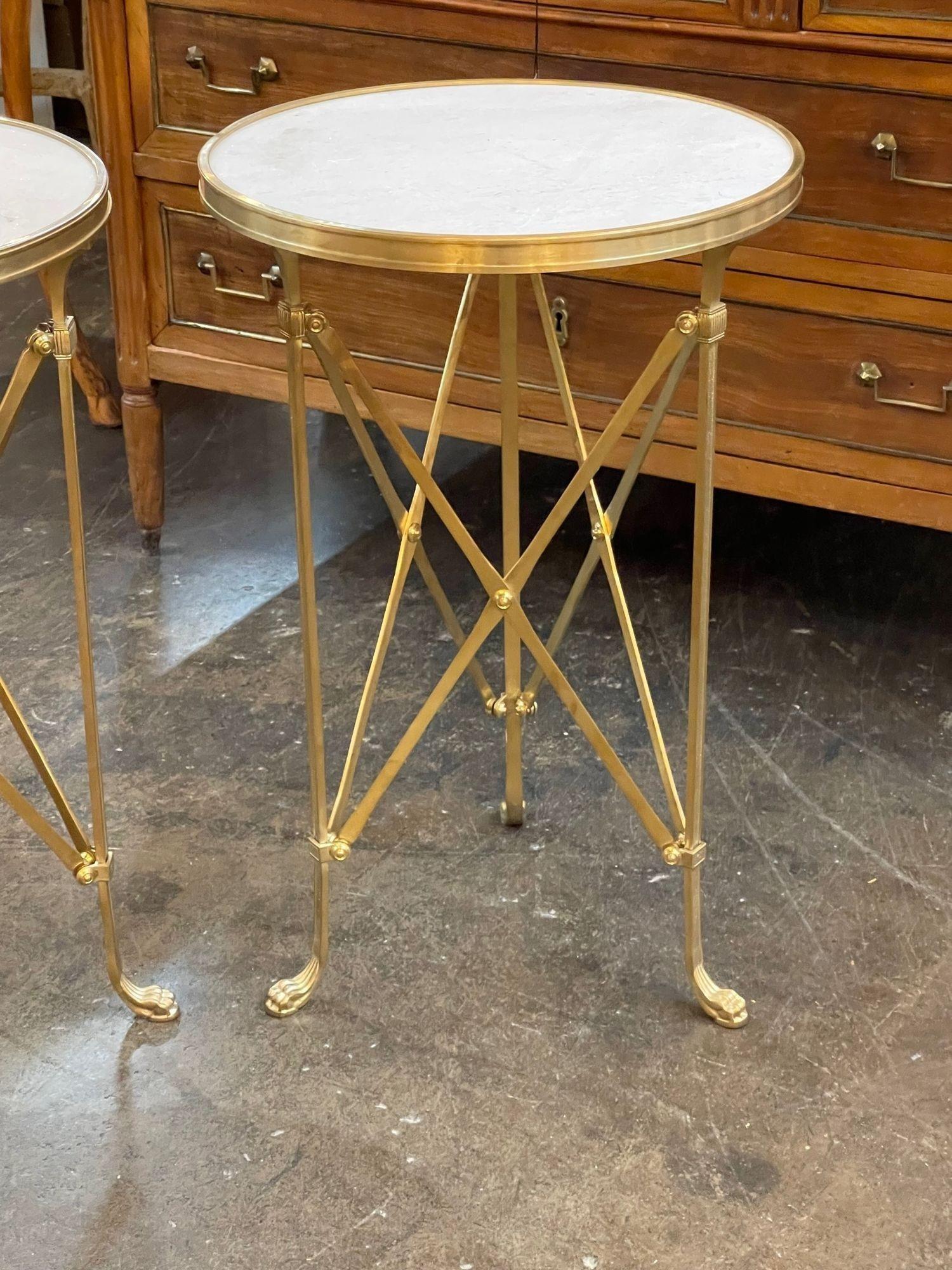Beautiful pair of French Directoire style gilt bronze and marble side tables. These tables are extremely fine quality and a gorgeous finish. Creates a very polished look!.
