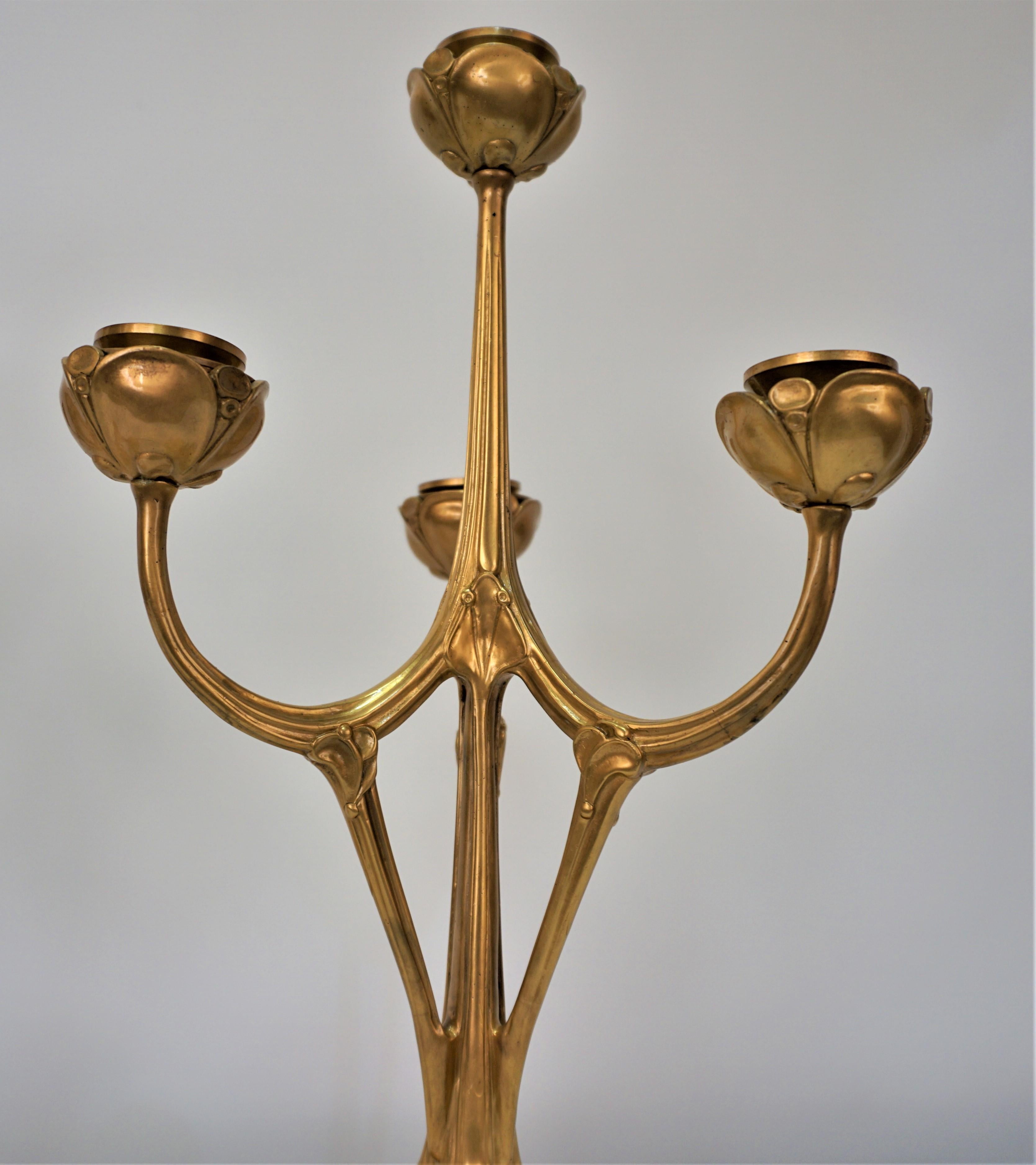 Simple but elegantly designed pair of gilt bronze candelabras.