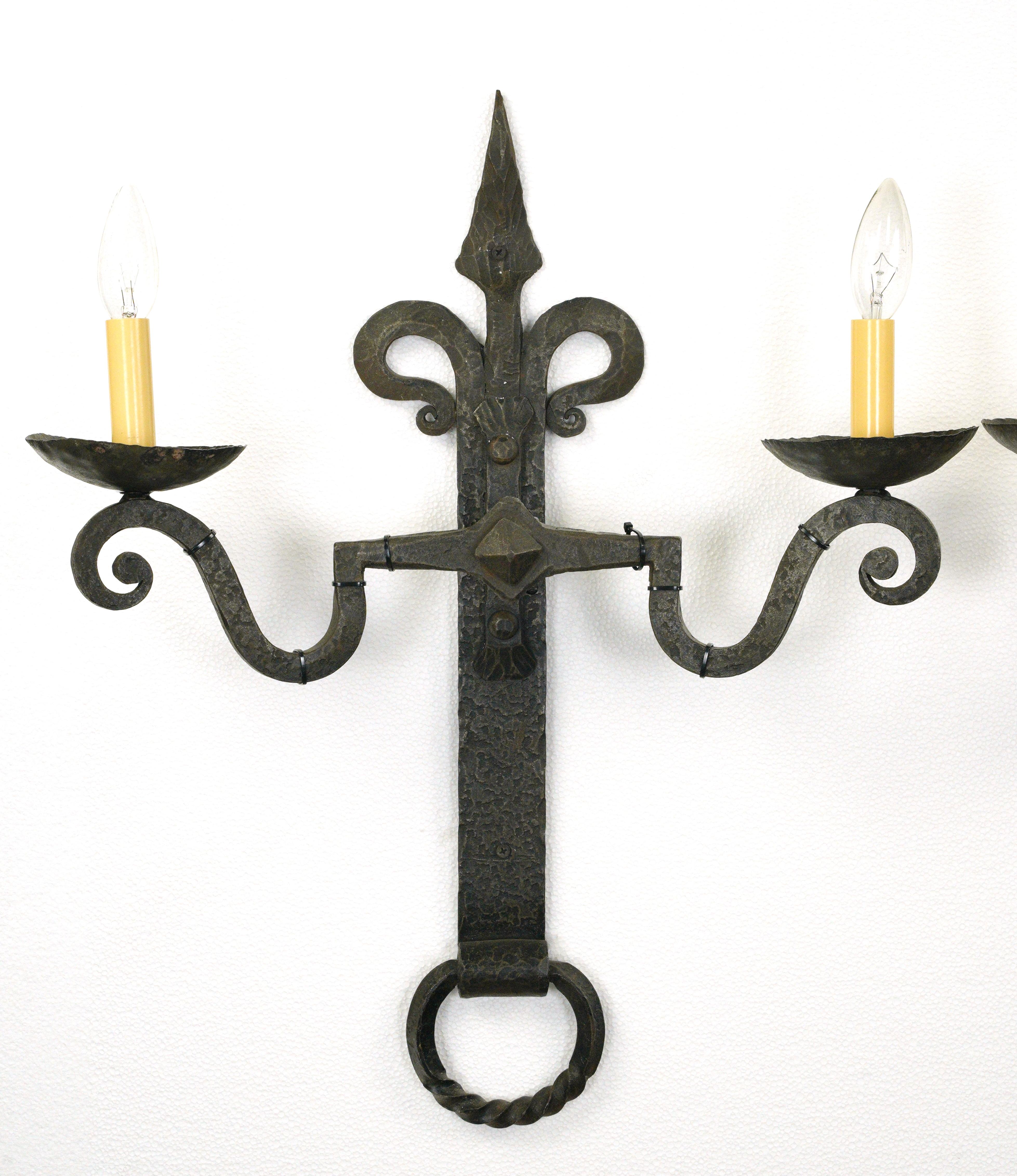 Pair of large hammered wrought iron two arm wall sconces from Belgium. These are in very good condition and newly rewired ready to install. Cleaned and restored. Small quantity available at time of posting. Please inquire. Priced each pair. Please