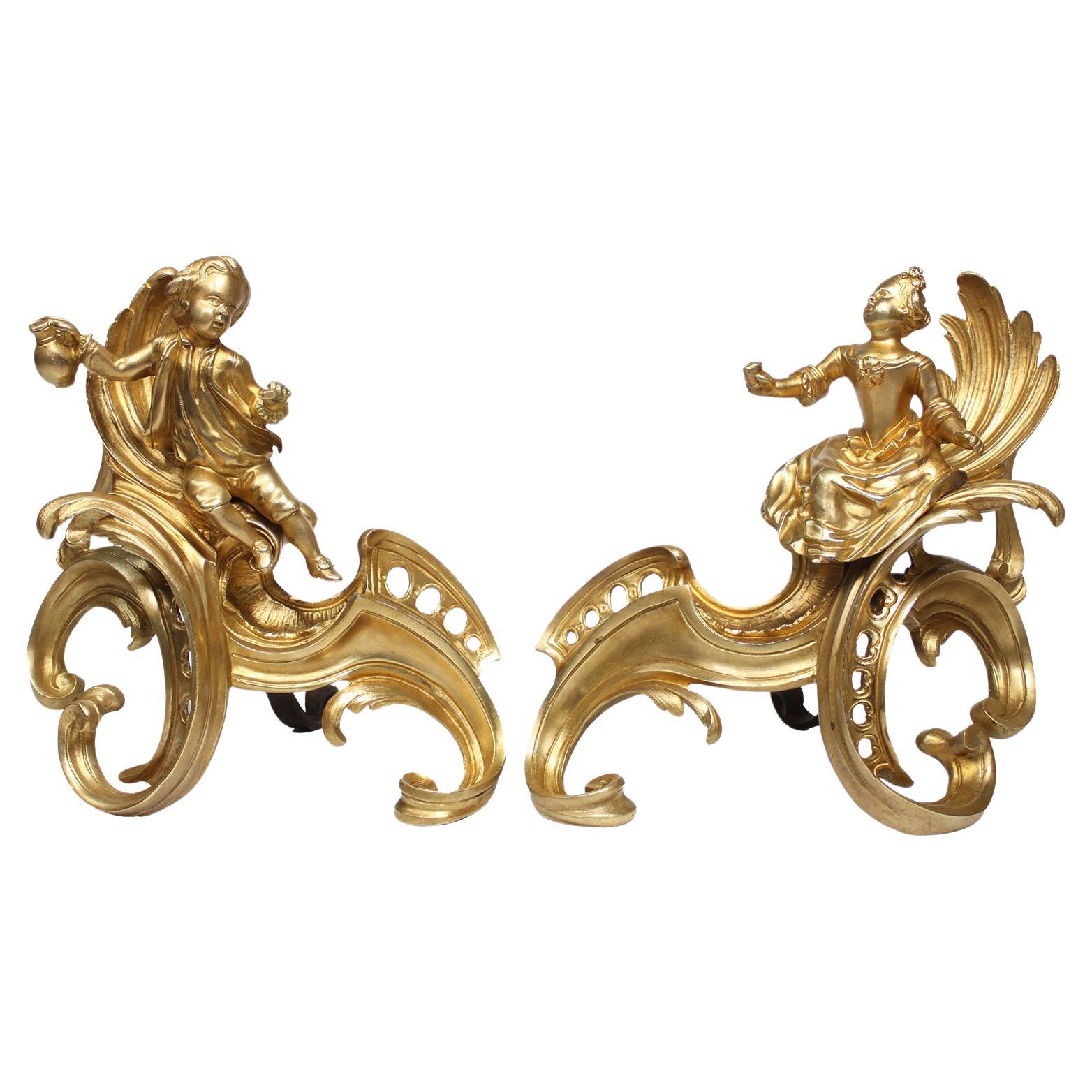 Paire d'andirons Chenets en bronze doré de style Louis XV du début du 19ème siècle
