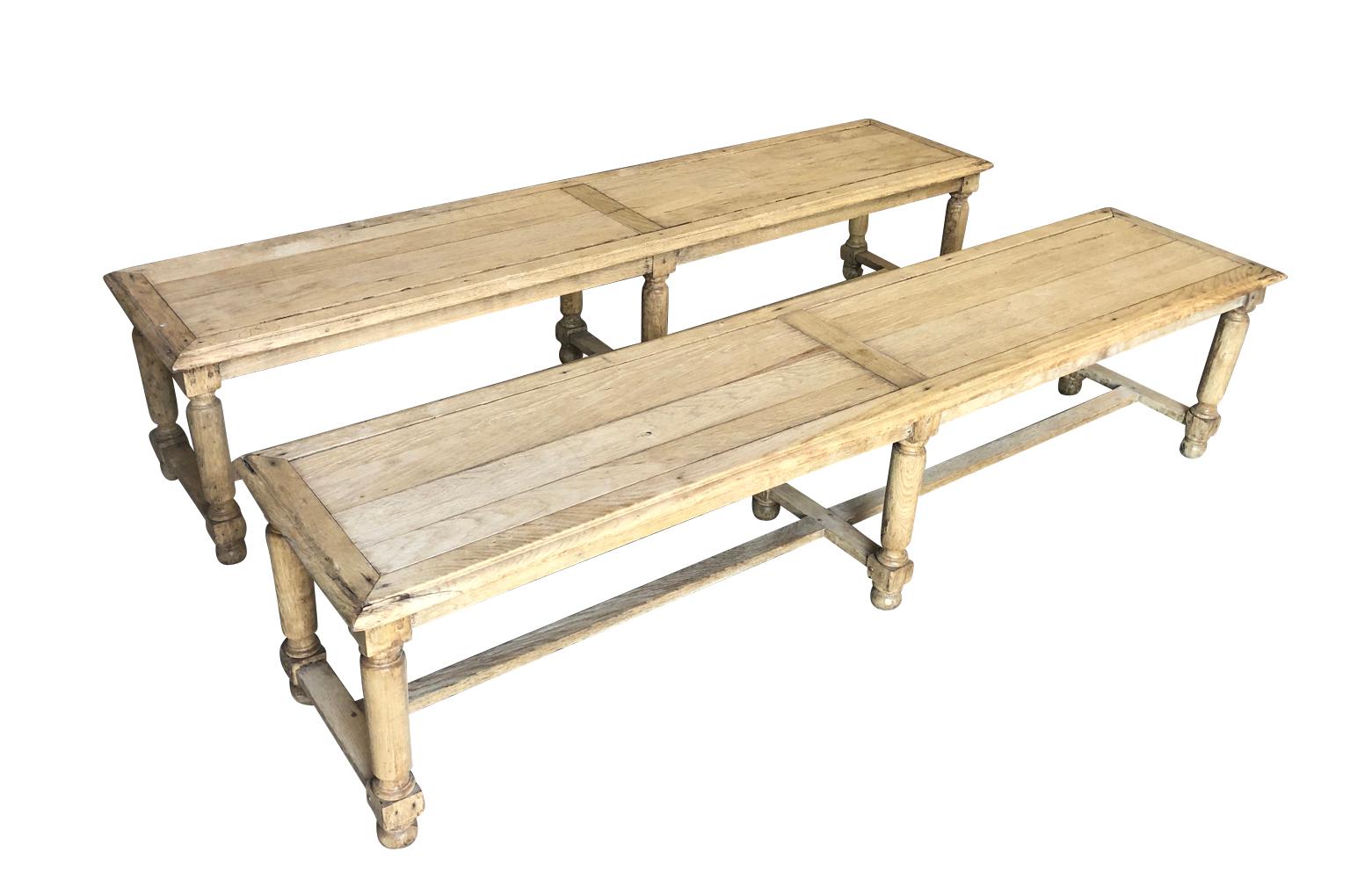 A very handsome pair of early 20th century benches from the South of France. Sturdily constructed from washed oak. Wonderful seating to accompany a large farm table.