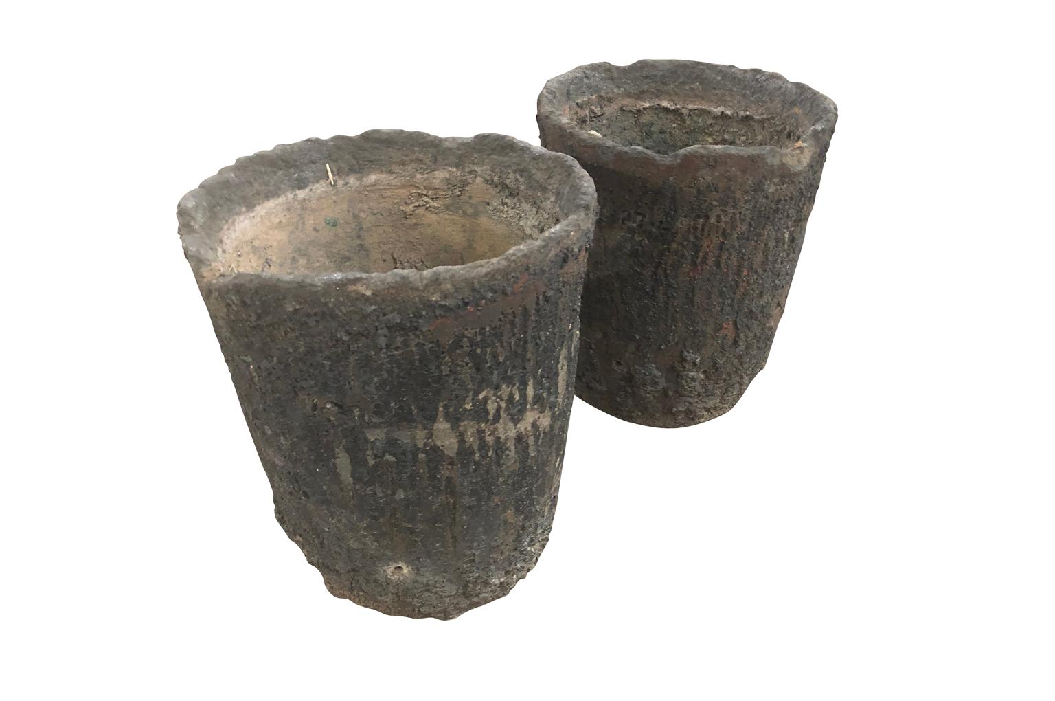 A wonderful pair of earlier 20th century French Foundry Pots, Creusets. Fabulous as jardinières or planters. Perfect for any interior or garden. A crucible was made from a material with a much higher melting point than what was going to be melted in