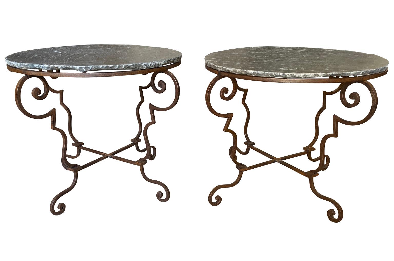 A charming pair of early 20th century side tables from the South of France. Wonderfully constructed with wrought iron bases and slate tops.