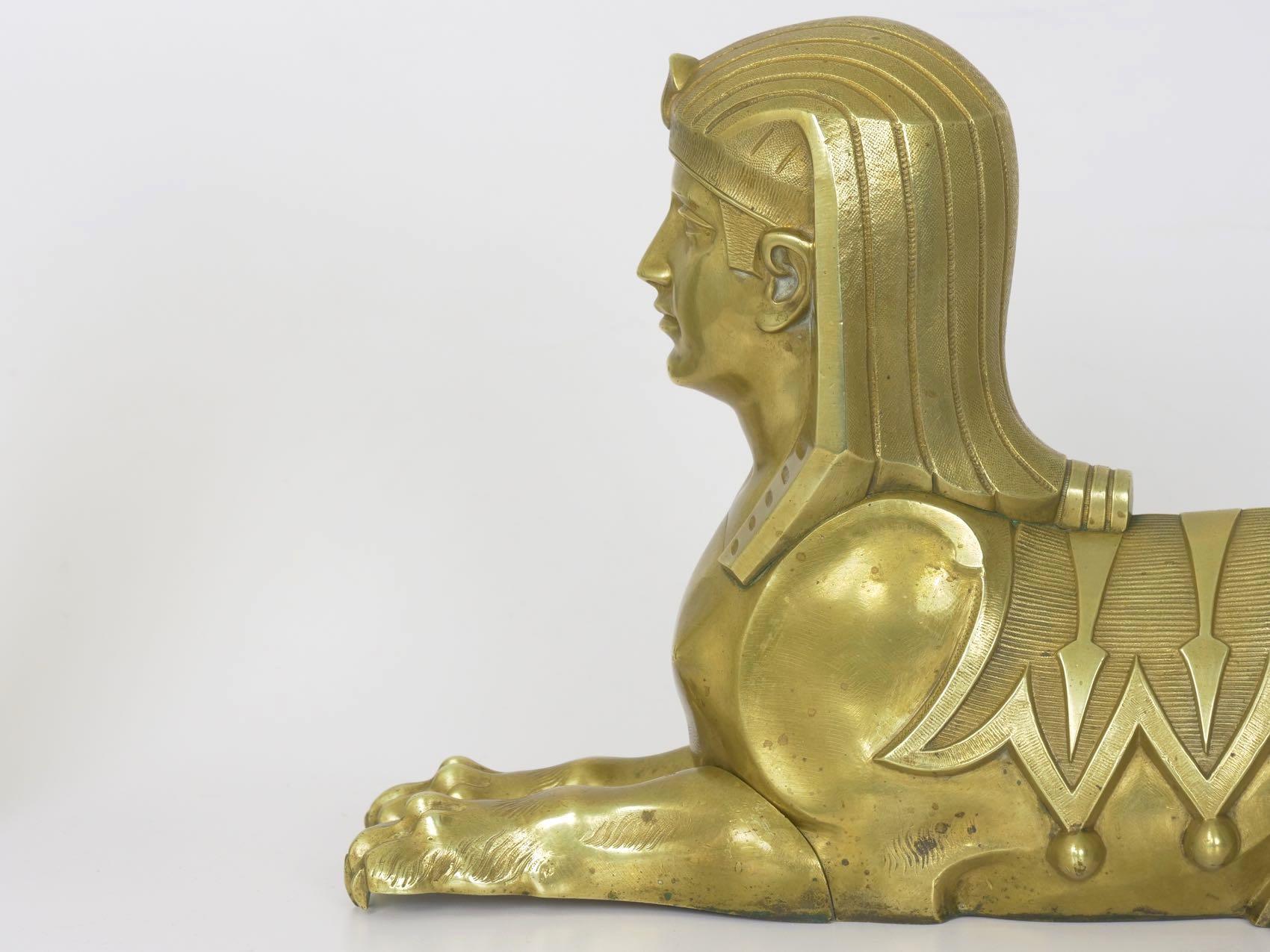 A very finely cast pair of Sphinx figurals in the Egyptian taste, they would originally have been arranged as flanking chenets, likely raised over a rectangular base where the claws would be allowed to overhang the edge slightly; this base would