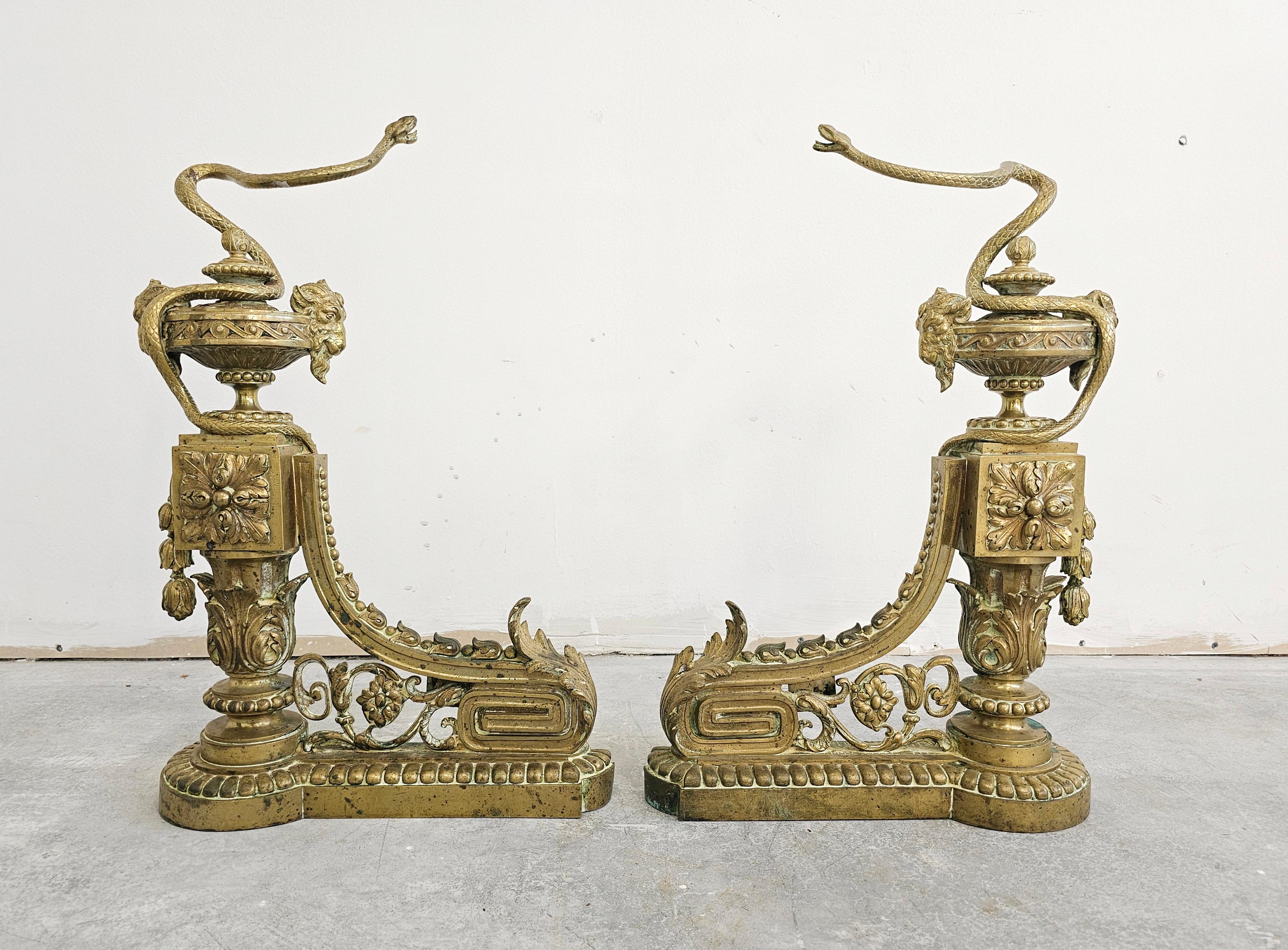In this listing you will find a pair of very rare French Empire andirons or chenets, completely done on brass. They feature carefully and precisely sculpted snakes in motion, as well as the ram heads. Made in France in 19th century.

Good antique