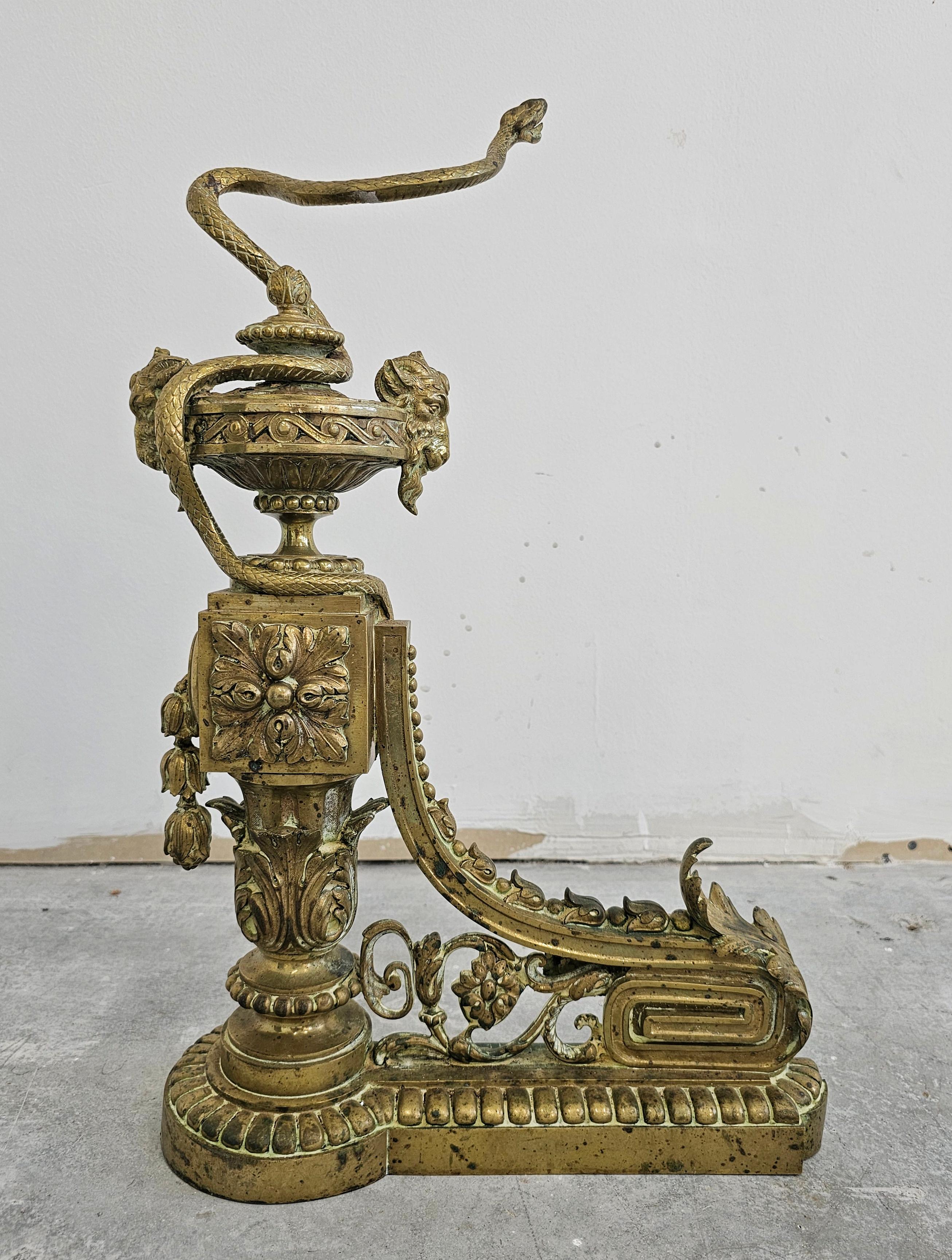 Pair of French Empire Andirons done in gilt brass, featuring snakes and ram head In Good Condition For Sale In Beograd, RS