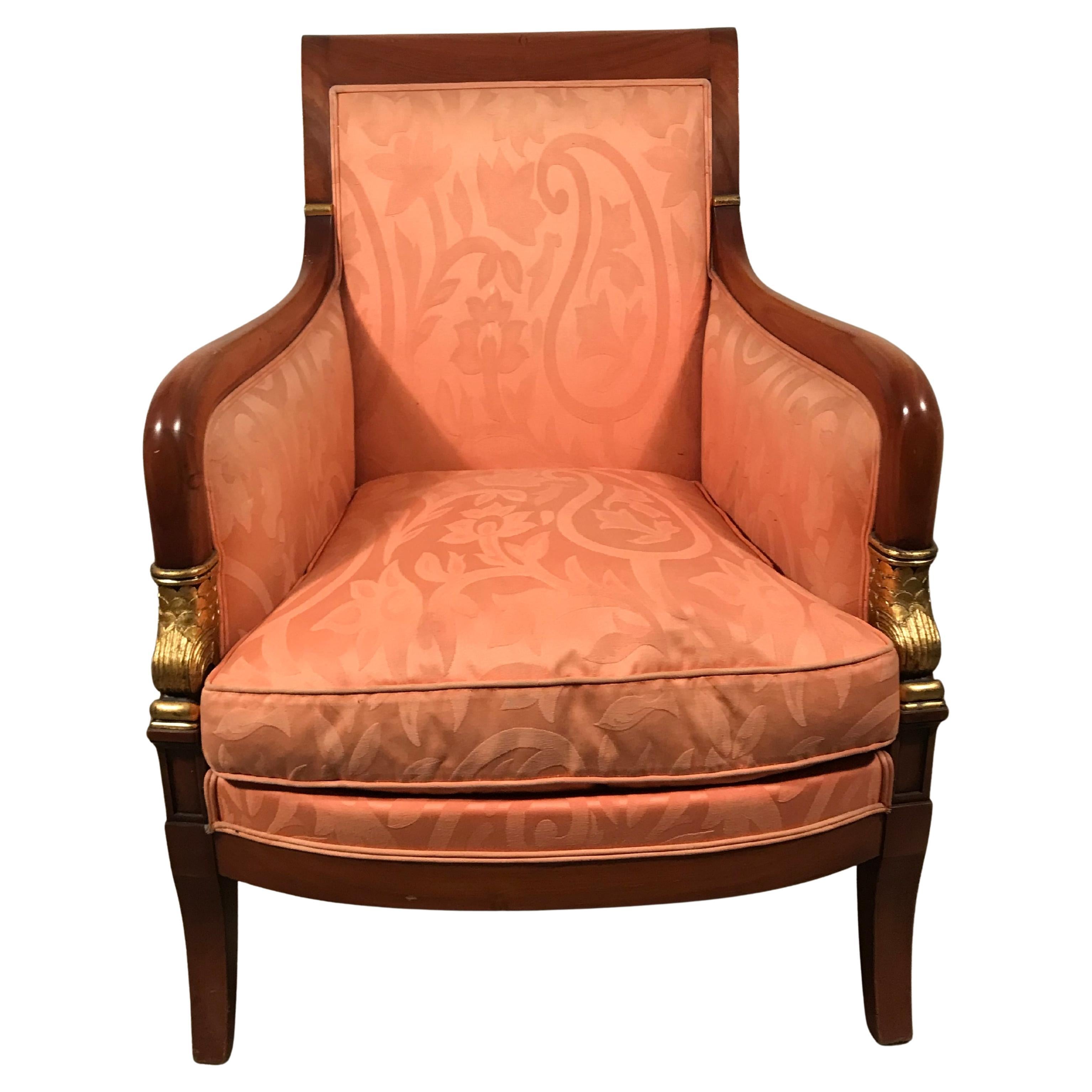 Discover an exquisite pair of Empire-style armchairs from the 19th century, crafted from luxurious mahogany. These elegant chairs embody timeless sophistication, featuring high backs and gracefully curved armrests that culminate in intricately