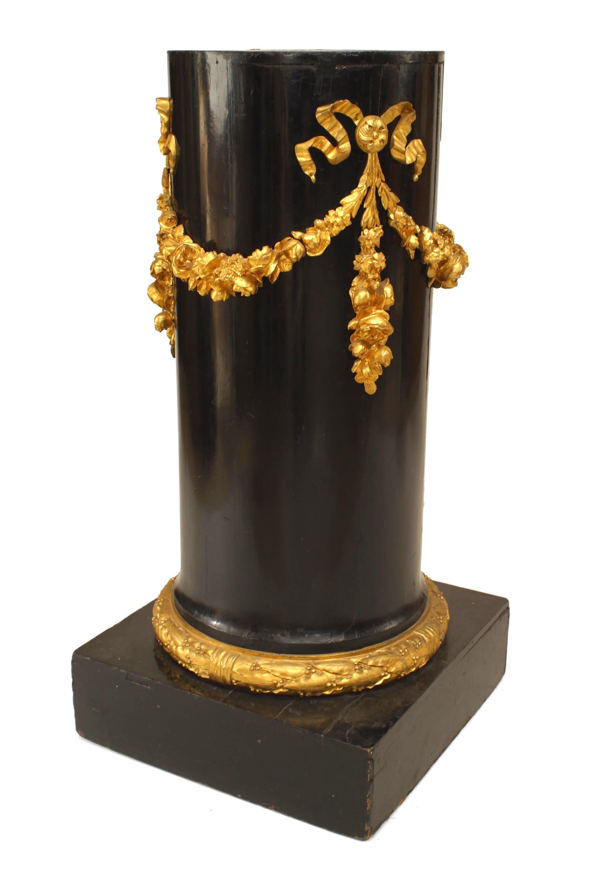 Pair of French Empire black lacquer column pedestals with bronze dore festoon trim.
