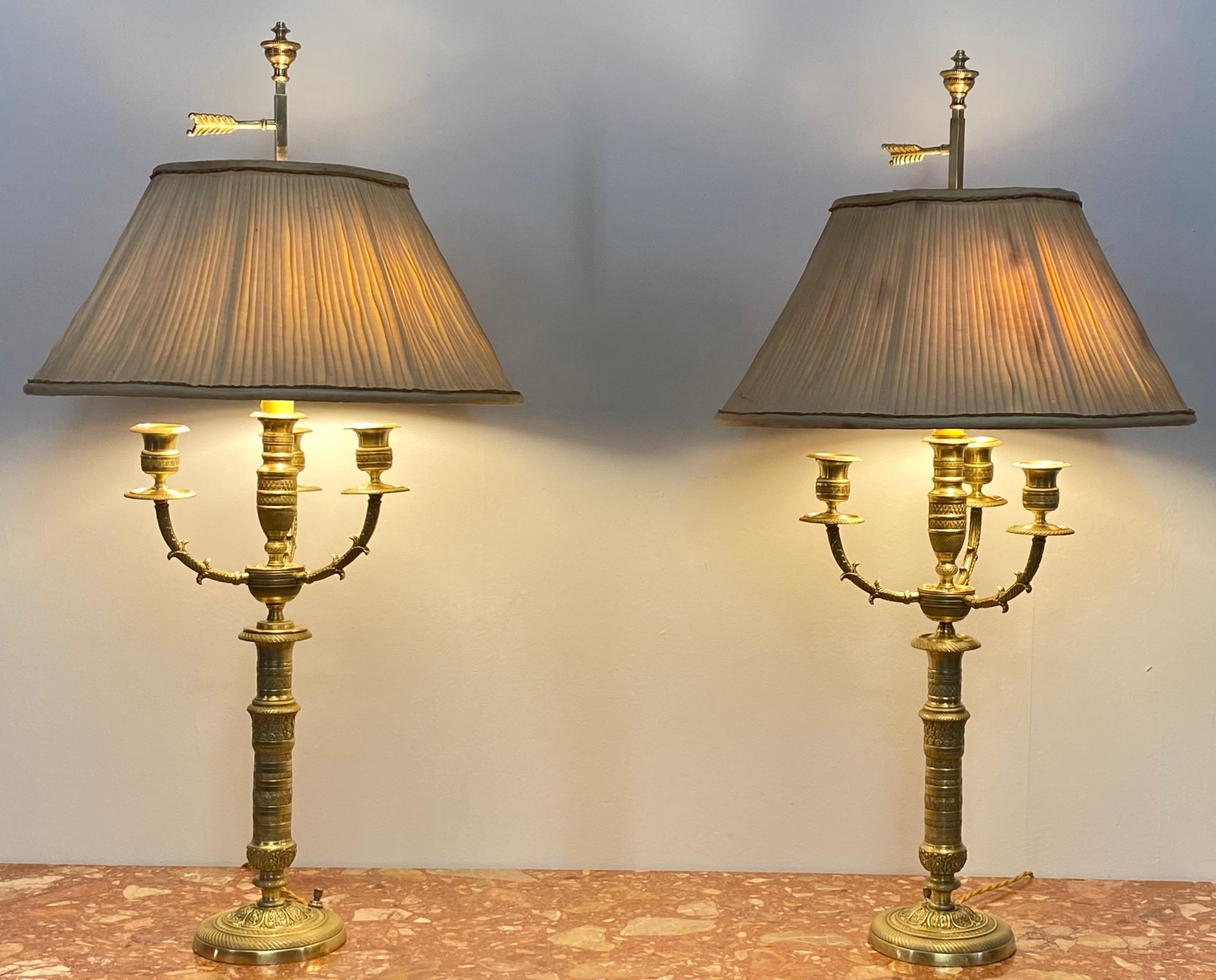 A pair of very fine quality 19th century brass candelabras, now converted to table lamps.
Professionally re-wired.
These have their original custom made shades, the shades show considerable damage to the fabric on the inside but the frames are in