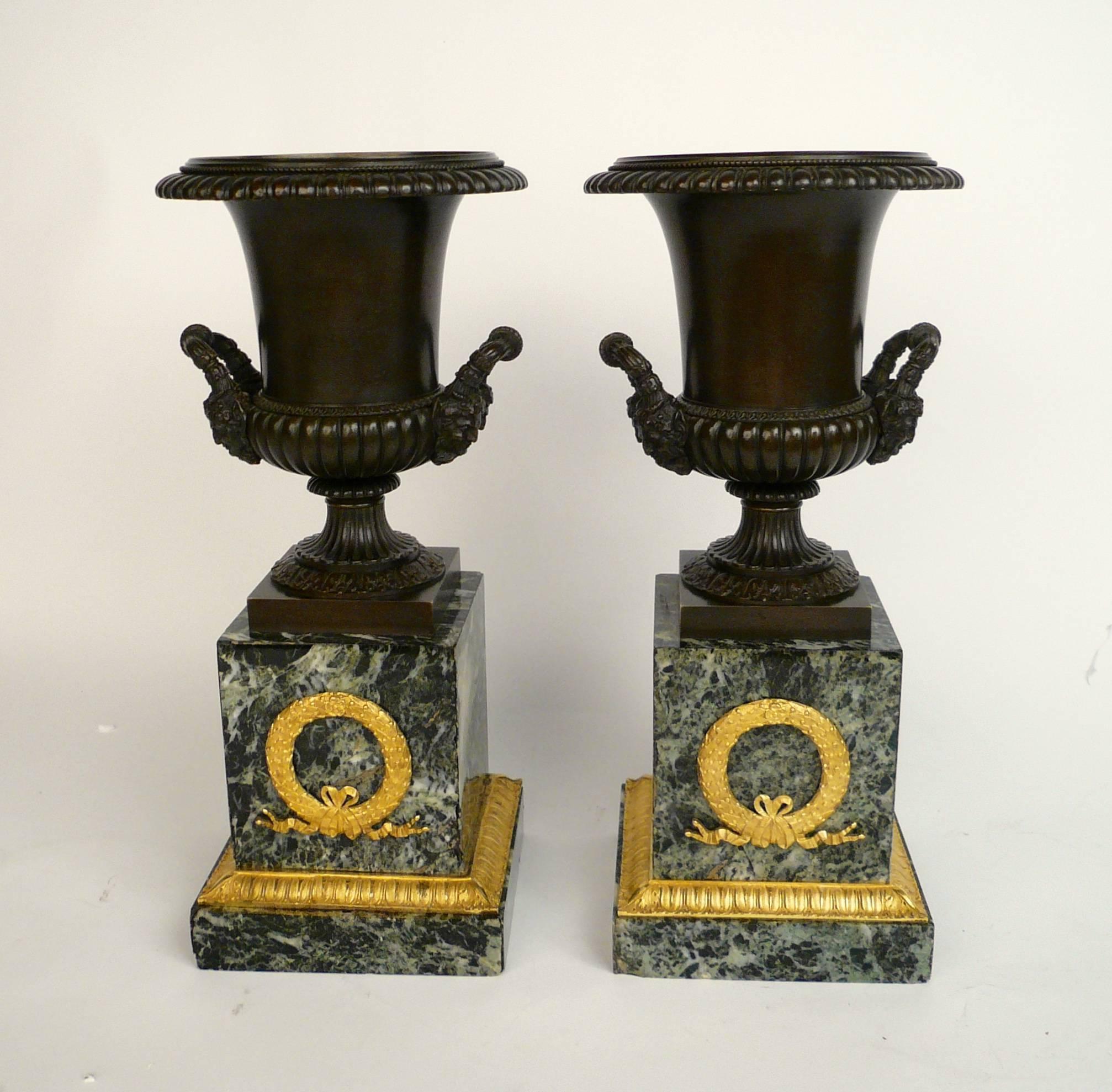 Patinated Pair of French Empire Bronze and Marble Urns For Sale