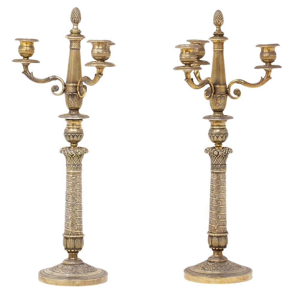 Coppia di candelabri francesi in bronzo impero e mercurio dorato
