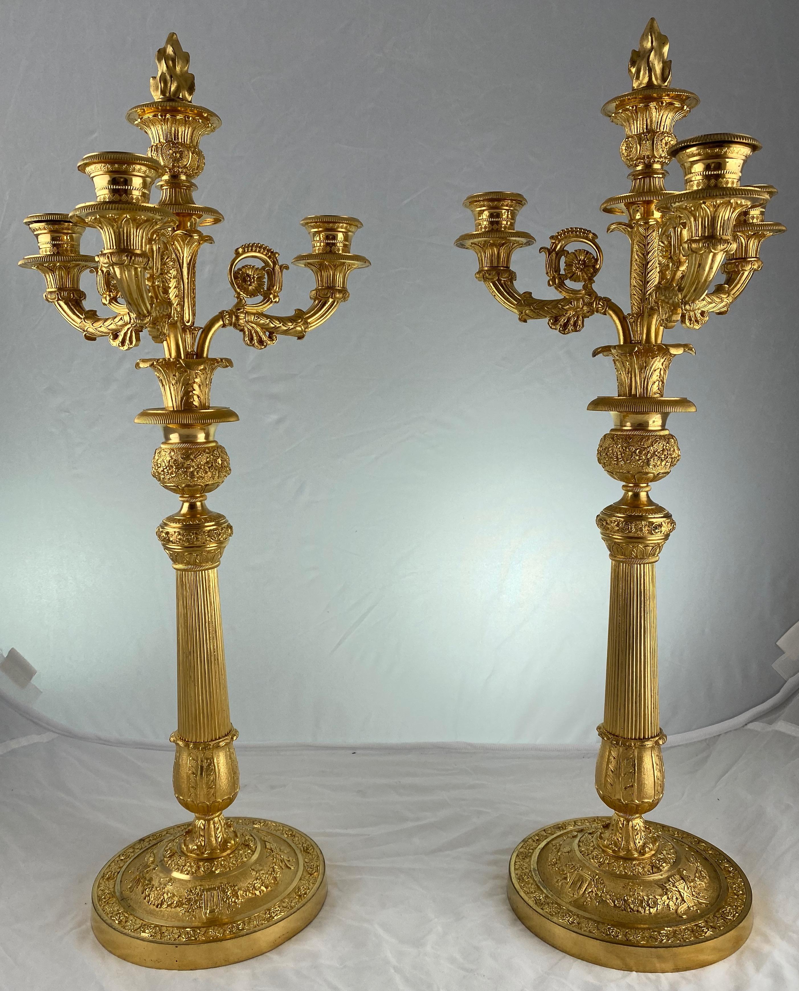 A pair of gilt bronze candelabra made around 1820-30. The candelabra have detachable candelabra-arms and can also be used as candlesticks.
