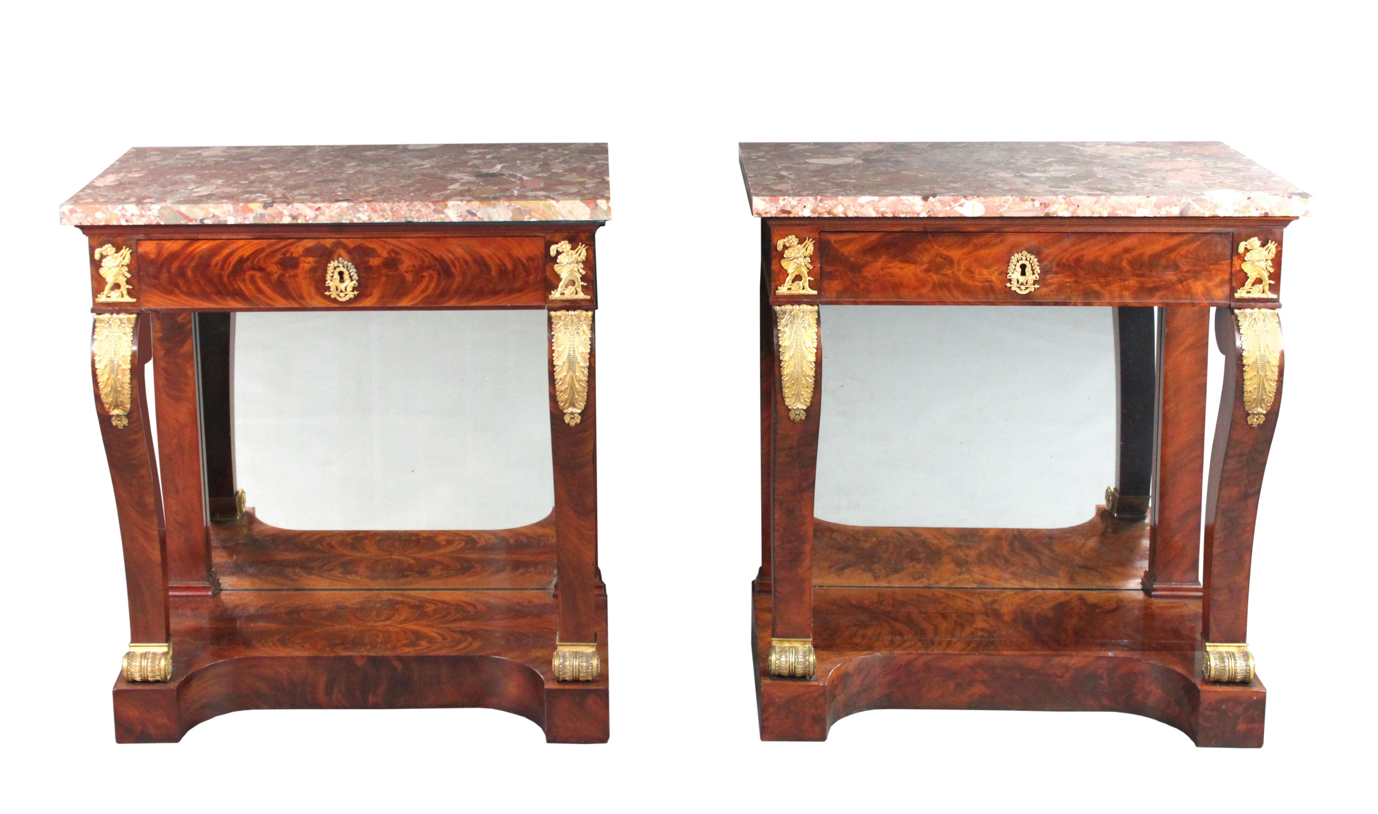 Pair of Empire console tables
A fine pair of Empire mahogany console tables with ormolu mounts of a lute player with other instruments at his feet, a leaf motif on the top of the legs and a very charming escutcheon of two squirrels; the tables have