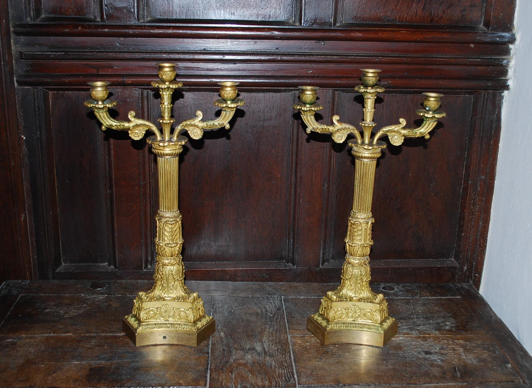 Hutton-Clarke Antiques is delighted to present a magnificent pair of French Empire Gilt Bronze Candelabra, originating from around 1890. These candelabra are a testament to the exquisite craftsmanship of the Empire era, showcasing meticulous casting