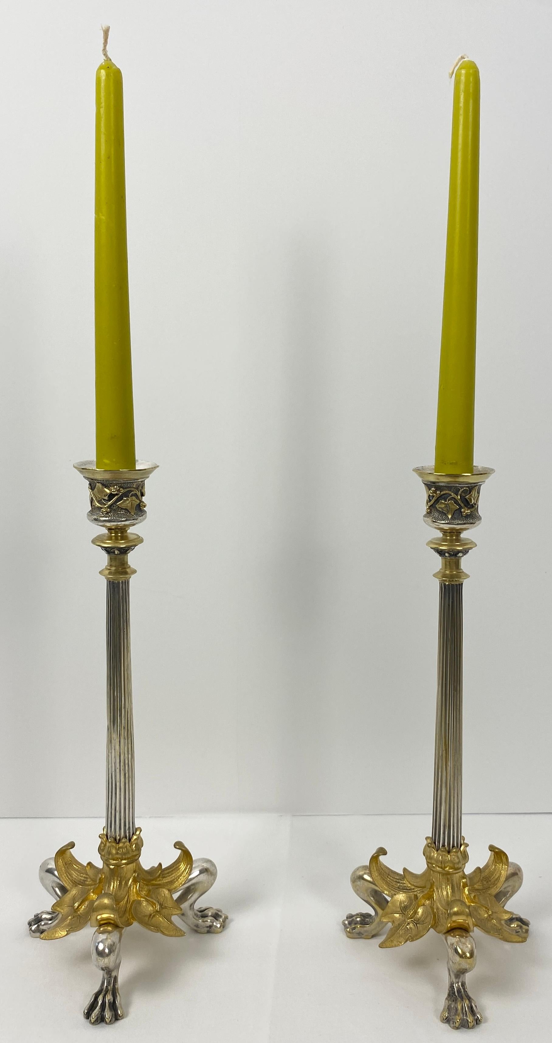 A fine Pair of French Empire gilt bronze candlesticks on hoofed faun feet, late 19th century.

A fluted column rises on three cloven-hoofed hocked faun legs and feet.
These antique candlesticks feature beautiful floral and leaf decors.

Measures: 