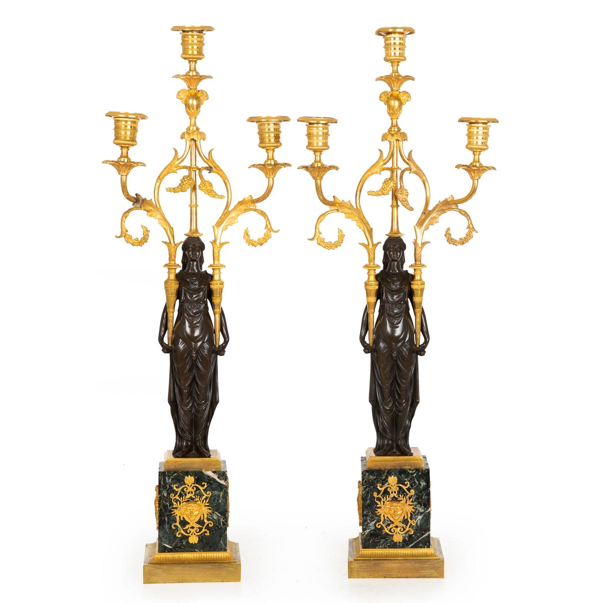 PAIR OF EMPIRE GILT AND PATINATED BRONZE THREE-LIGHT CANDELABRA
Paris, France ca. 1815-35  raised on antico verde marble plinths

25 1/2