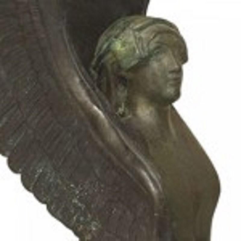 Pair of French Empire style (19/20th Cent) green patinated bronze winged sphinx figures (bookends) raised on a black marble pedestal base
