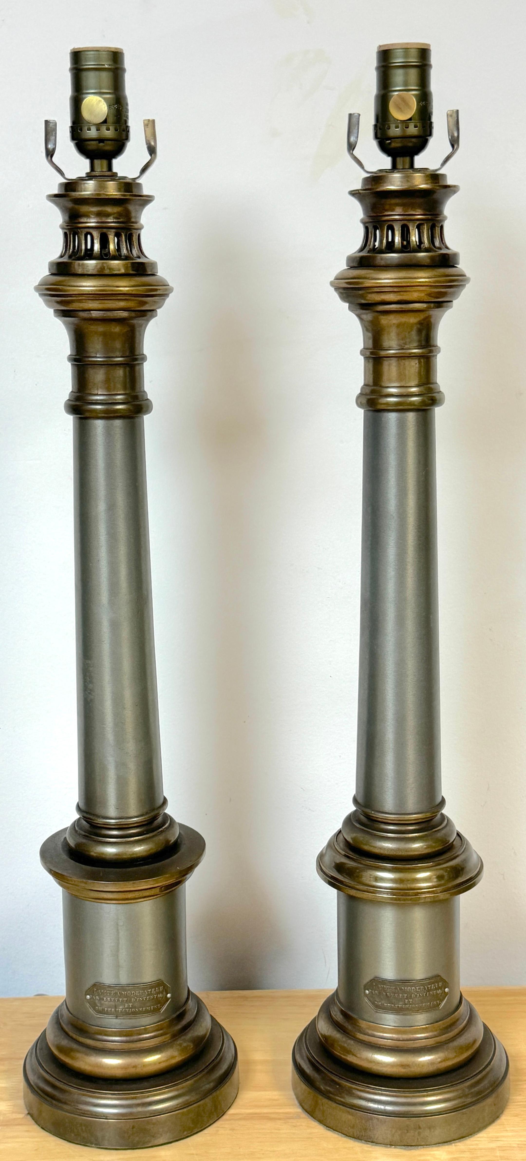 Pair of French Empire Lampea A. Moderateur Steel & Brass Column Lamps 
France, circa 1830s

A stunning pair of French Empire Lampea A. Moderateur Steel and Brass Column Lamps from the 1830s. Each lamp stands 26.5 inches high to the top of the socket