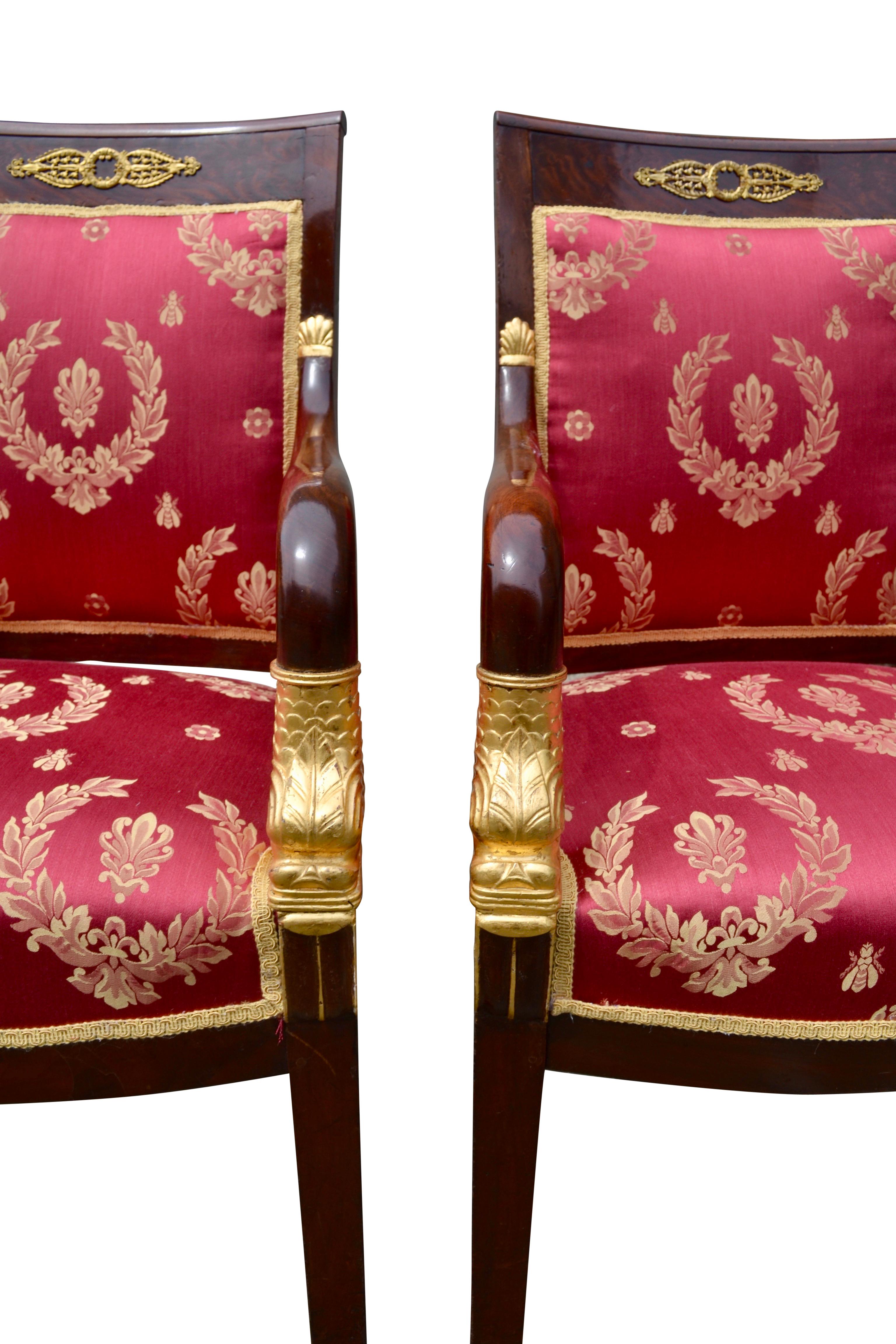 Silk Pair of French Empire Mahogany Armchairs Accented by Gilded Dolphin Heads