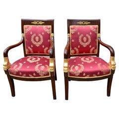 Pair of French Empire Mahogany Armchairs Accented by Gilded Dolphin Heads