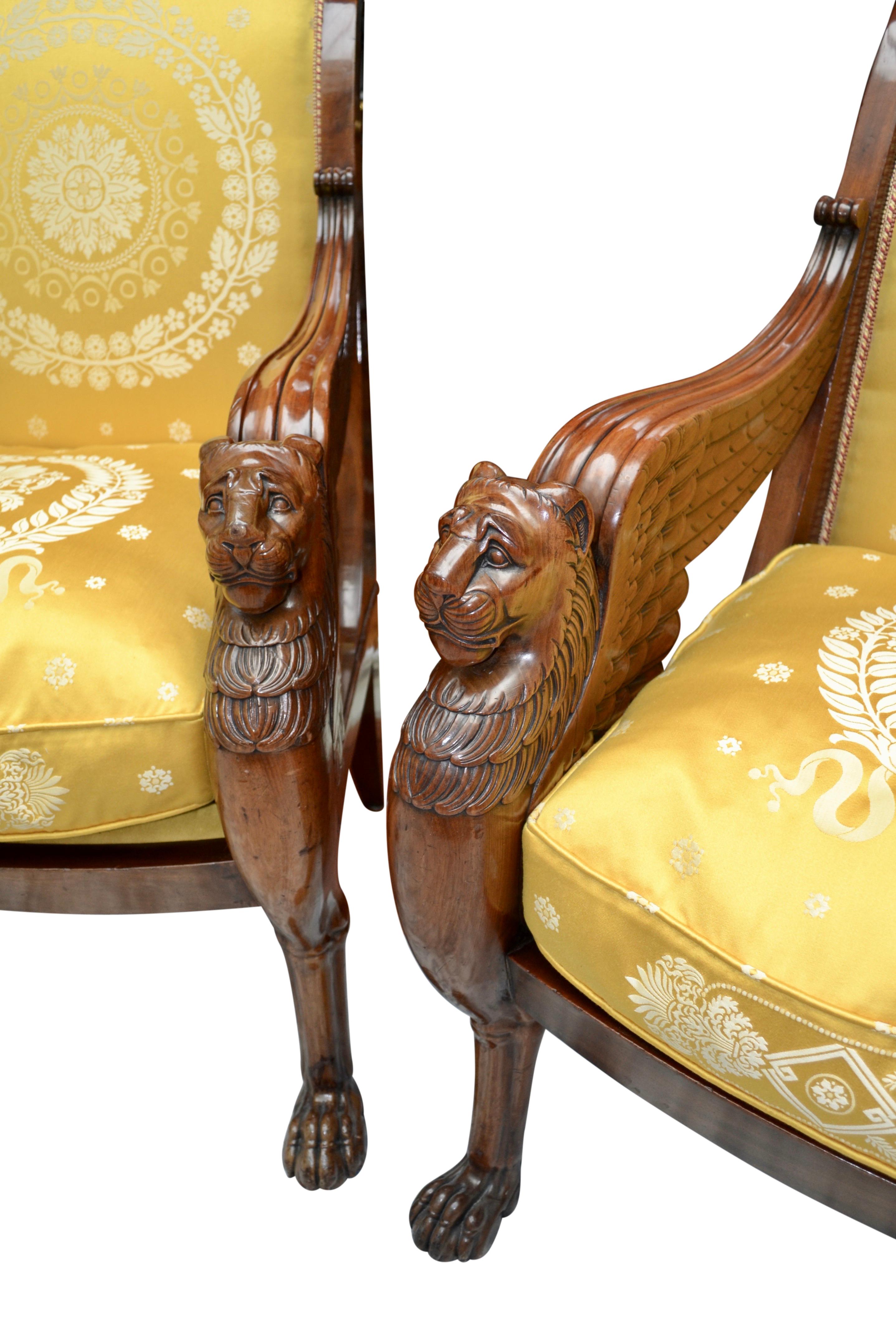 A pair of  imposing very rare  French Empire style armchairs attributed to the firm of Jacob Desmalter; the front legs crisply carved as winged lions with hairy paw feet; the lion’s wings extending to the curved back rail; likely made in the second