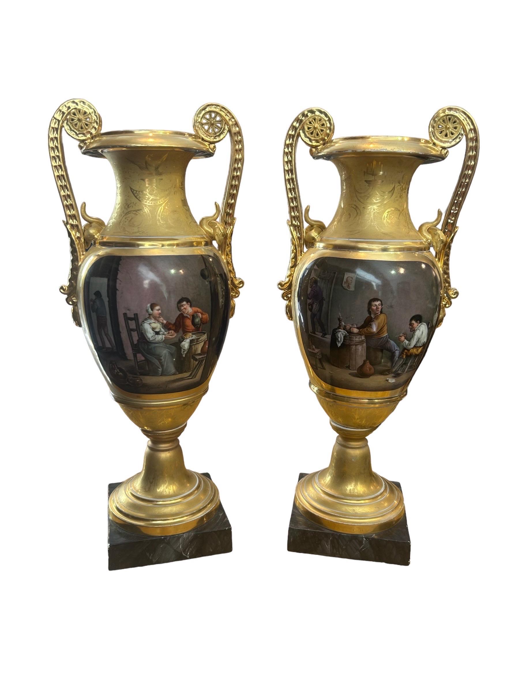 Pair of Empire period amphorae in gilded porcelain painted in polychrome neoclassical scenes, France. Signed, Gauchin, f. 