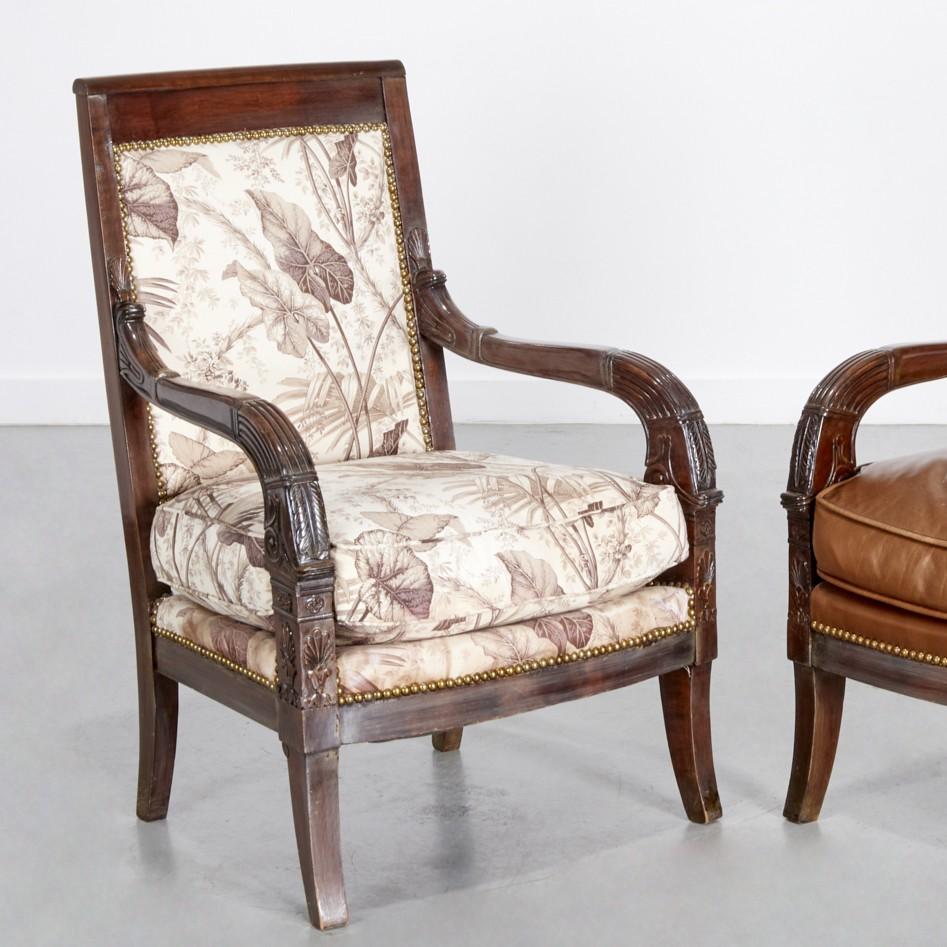 Ein fein abgestimmtes Paar französischer Empire-Fauteuils, jeweils mit rechteckiger gepolsterter Rückenlehne, abnehmbarem gepolstertem Sitz und elegant geriffelten und geschnitzten Armen. Die Mahagonirahmen weisen reiche Schnitzereien an den