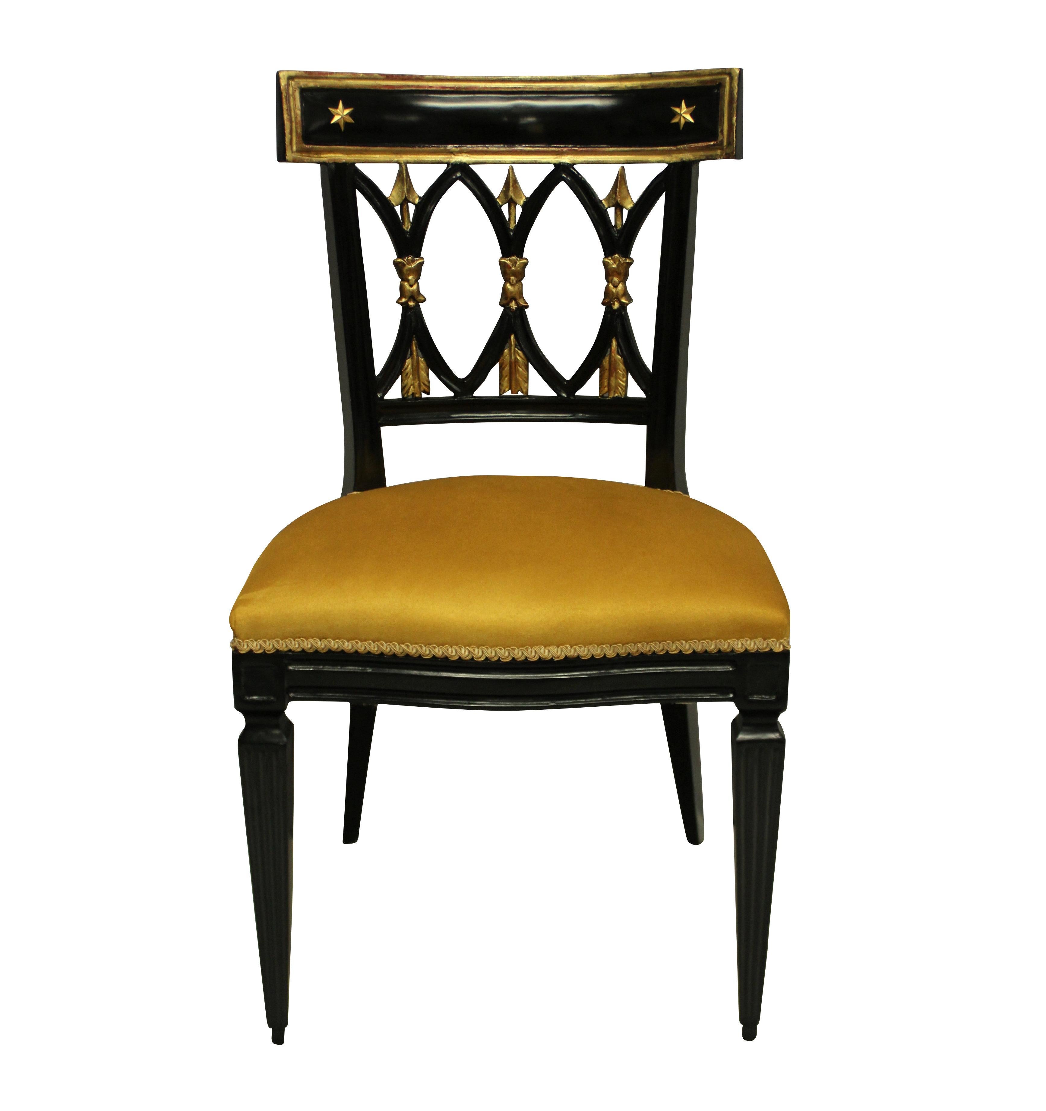 A pair of French ebonised & parcel gilt Empire Revival hall chairs. With gilt bronze stars to the back rail and depicting arrows. Newly upholstered in mustard faux suede.