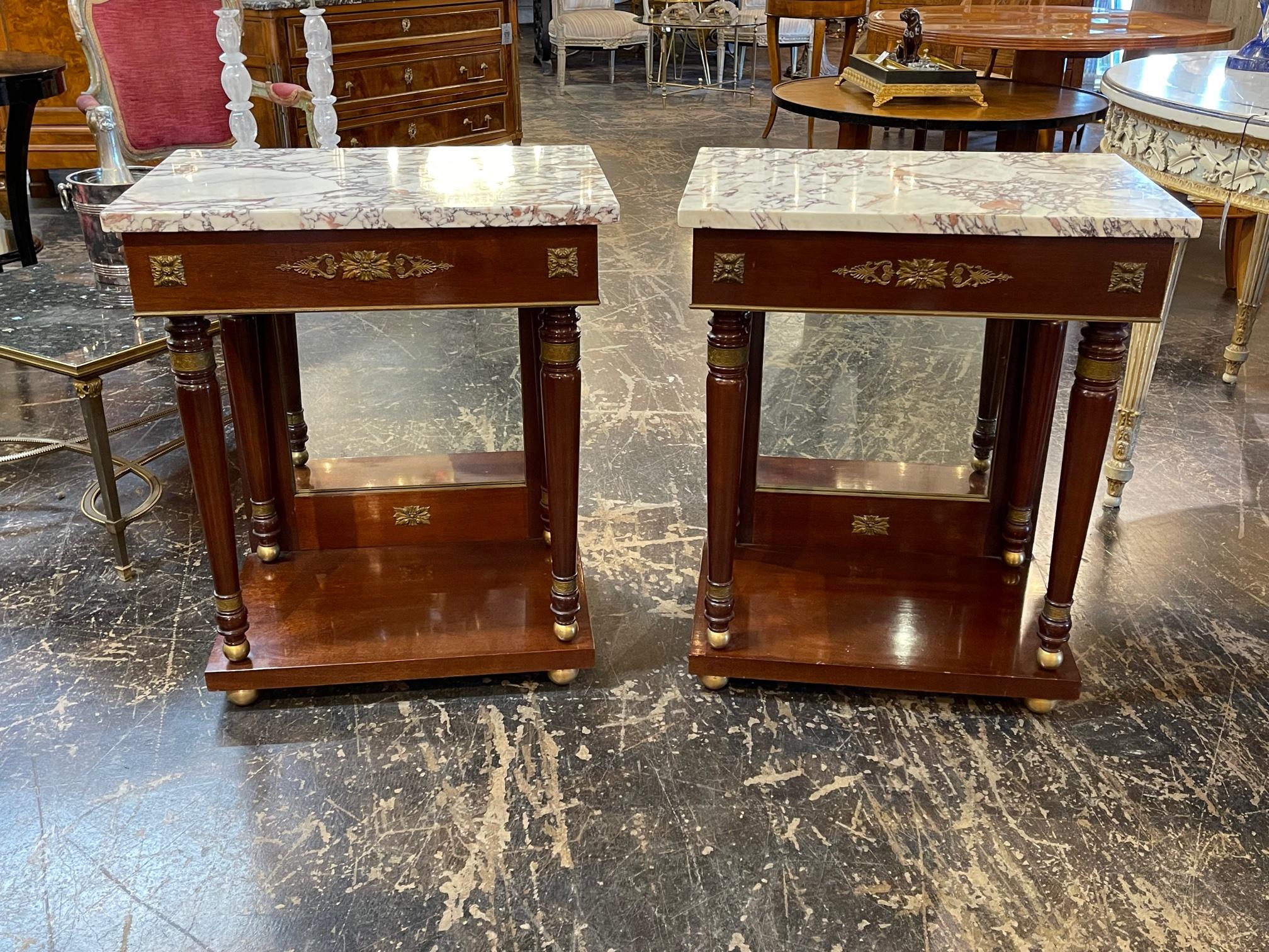 Fine pair of French Empire mahogany and gilt bronze side tables with breccia marble. Circa 1860. A fine addition to any home.