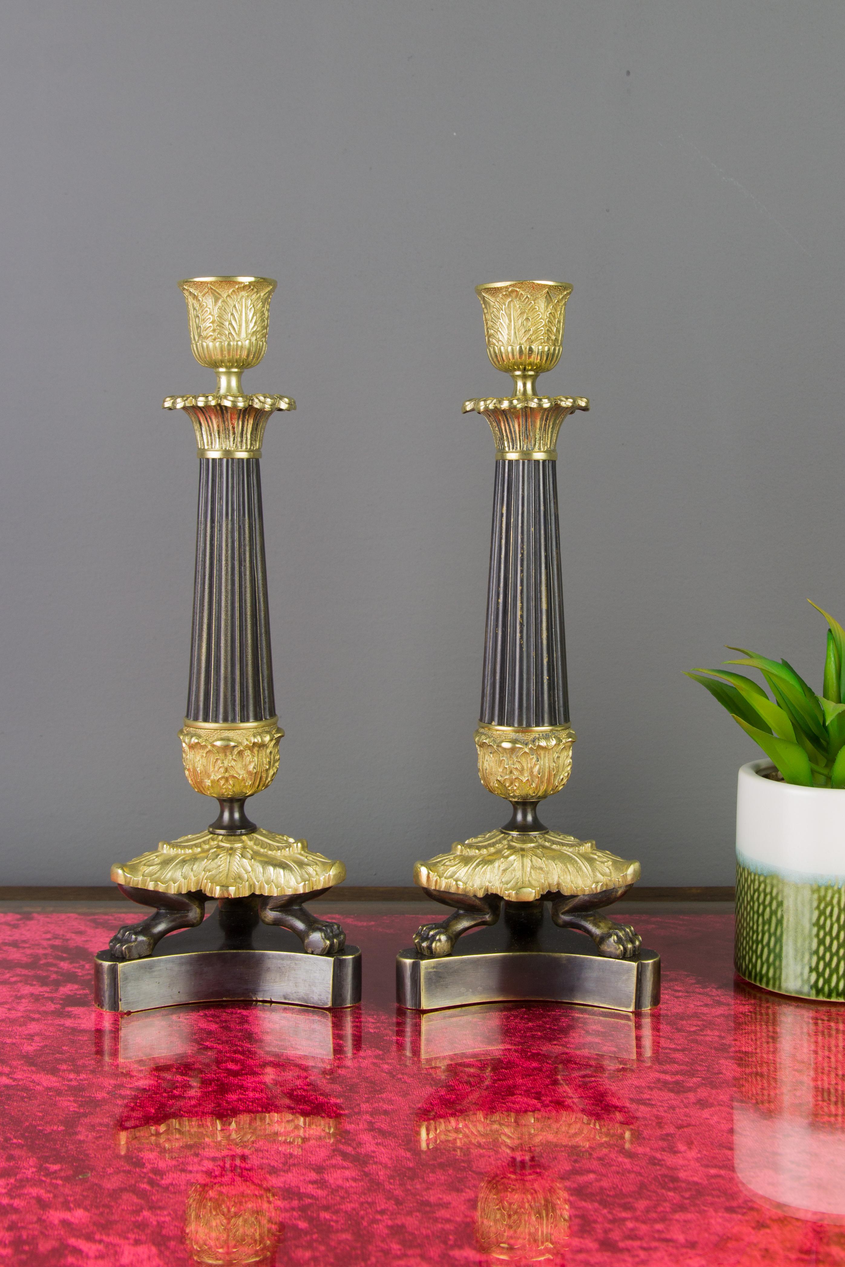 Patinated Pair of French Empire Style Bronze and Brass Candlesticks on Tripod Base For Sale