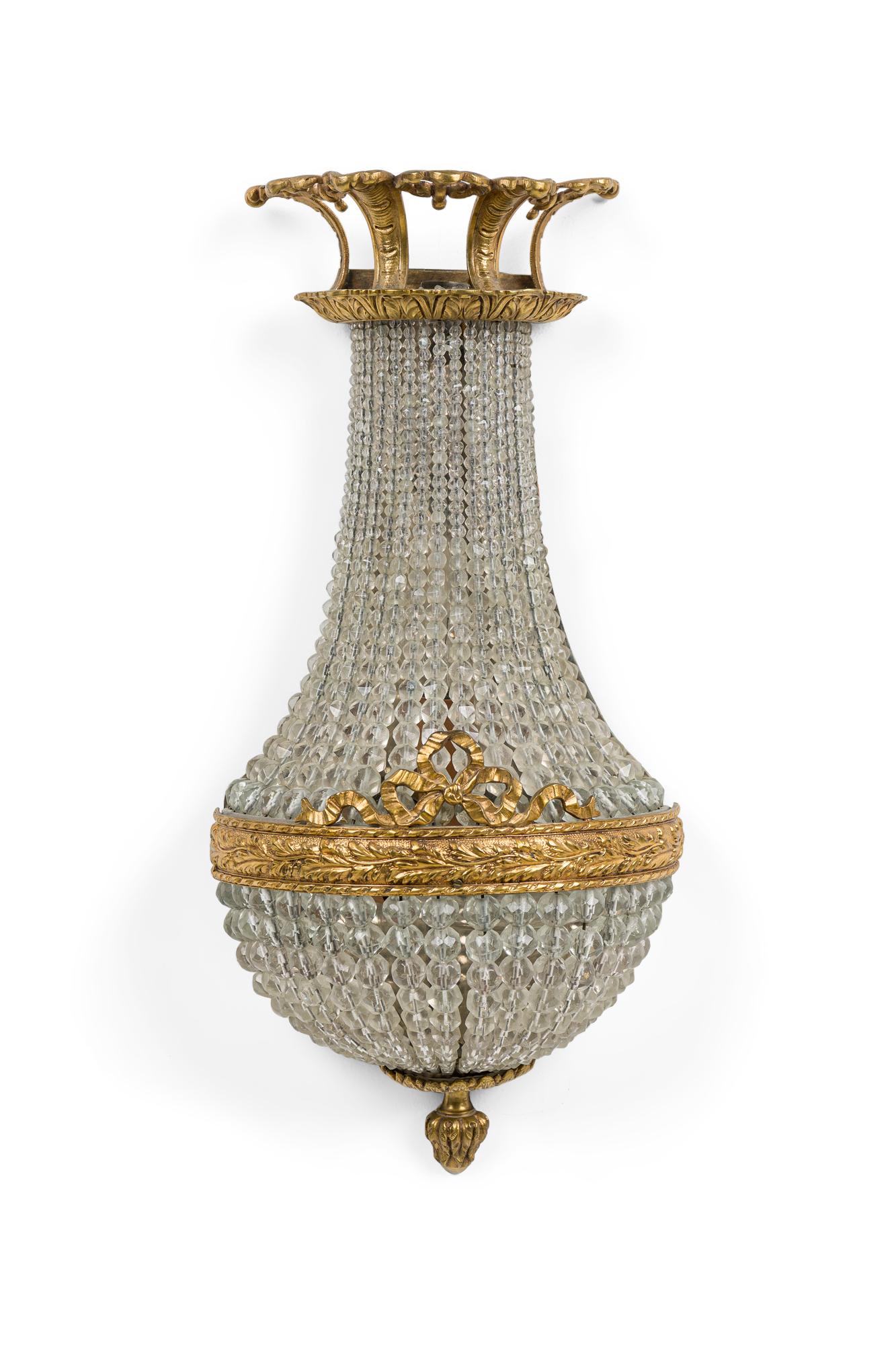 PAIR of French Victorian style (1929s) wall sconces with a gilt bronze frame having intricate designs of acanthus leaves and ribbon on the body and a scalloped canopy with cascade of crystal beads and acorn finial bottom (PRICED AS PAIR)
