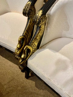 Pair of French Empire-Style Ebonized and Parcel Gilt Bergeres
