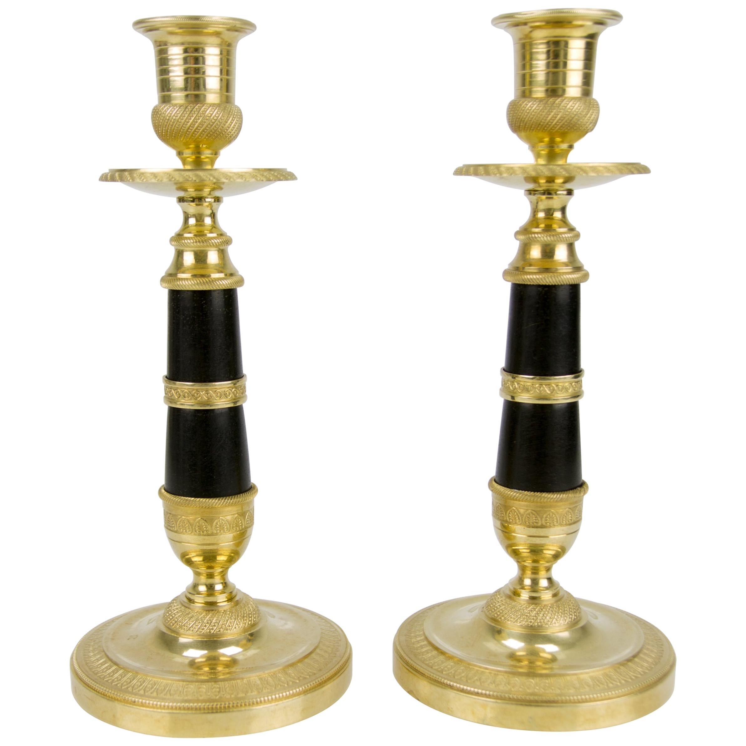 Pair of French Empire Style Gilt Bronze and Patinated Brass Candlesticks For Sale