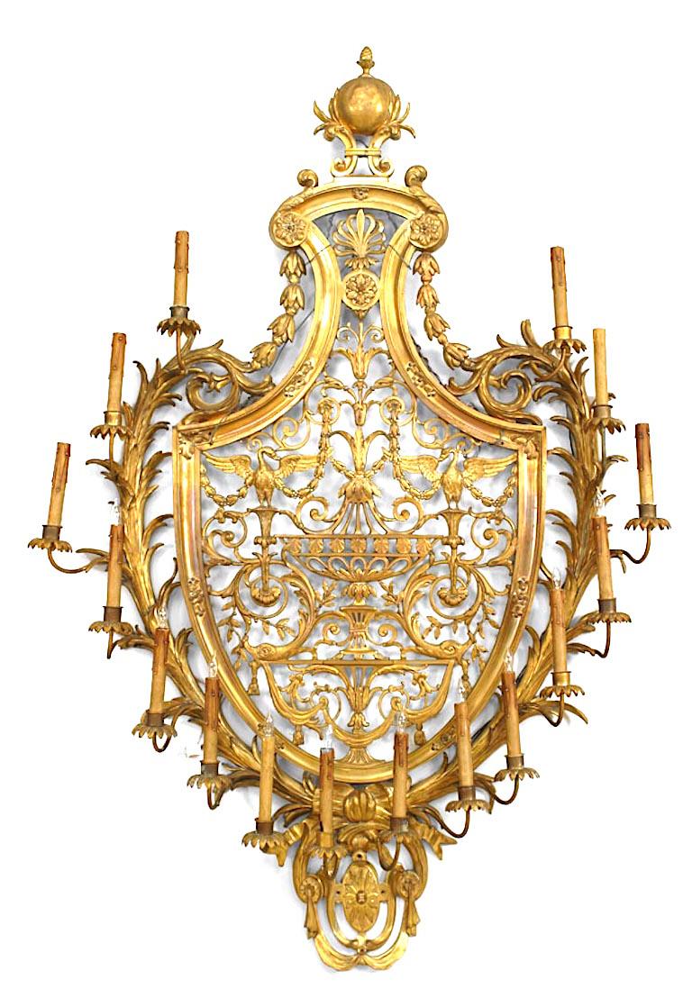 Pair of French Empire-style (late 19th Century) ormolu wall sconces with sixteen arms, and shield form back plates with crossed palm fronds surrounding a scrolling vine cast pierced interior (Prob. CALDWELL, late 19th Cent)
