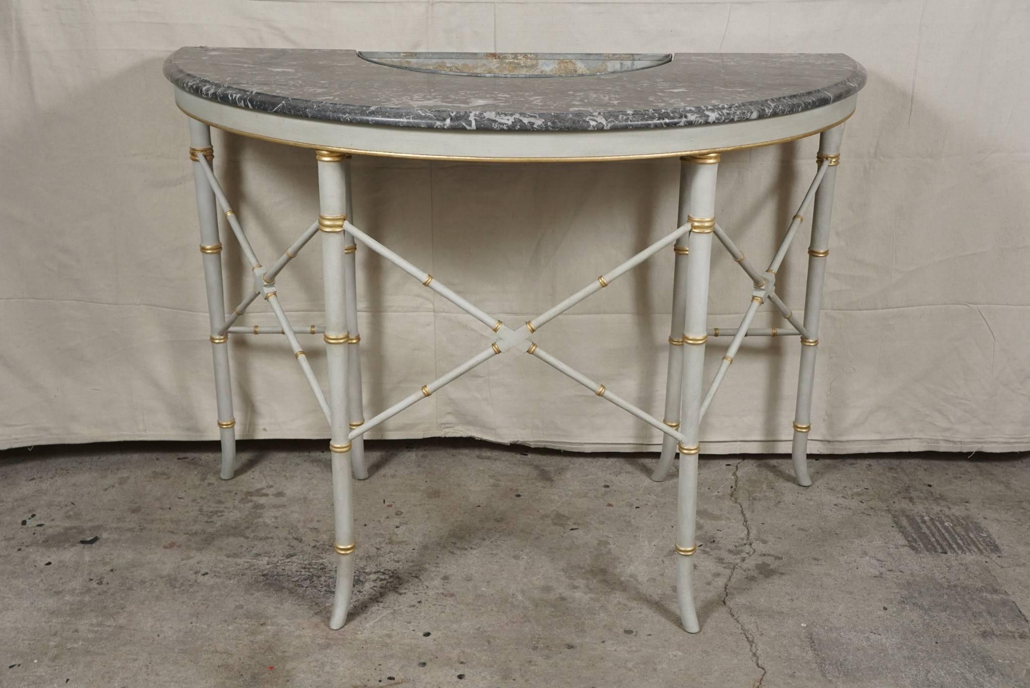 The pair of tables, clearly custom-made, are French and were made in the 1930s. Made as faux bamboo turned in a good hardwood and painted and gilded the tables are elegant and chic. Originally painted red and now painted a very delicate grey the