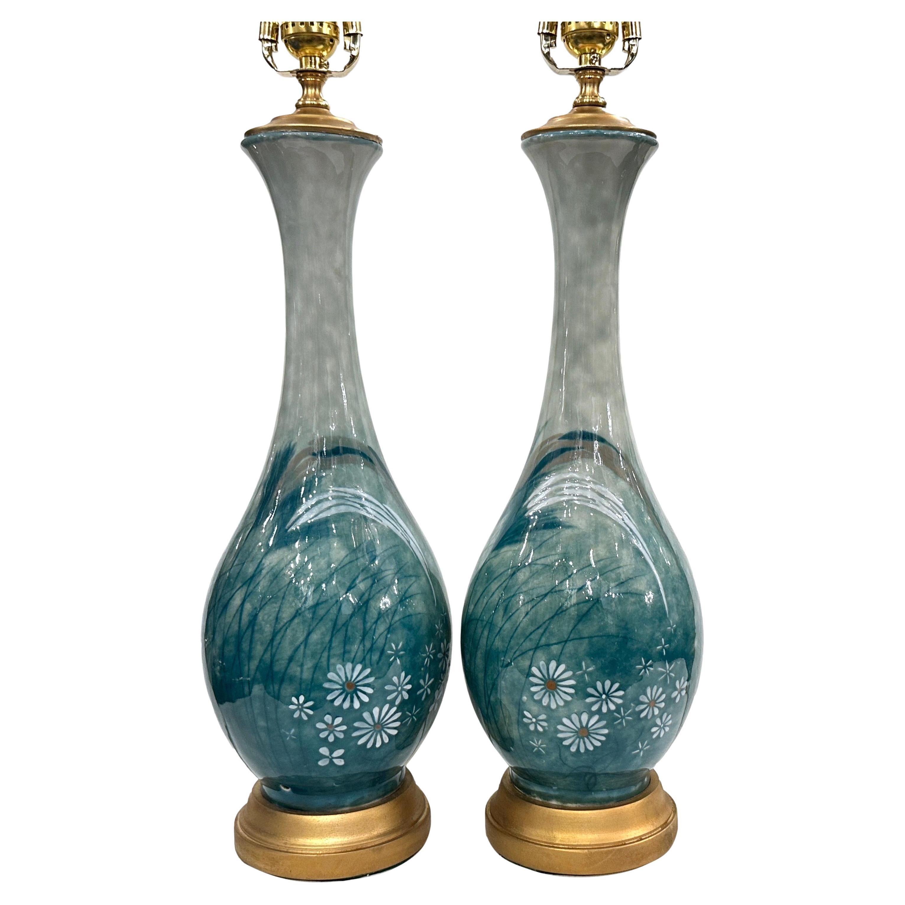 Pair of circa 1950's French porcelain table lamps with floral decoration 

Measurements:
Height of body: 18