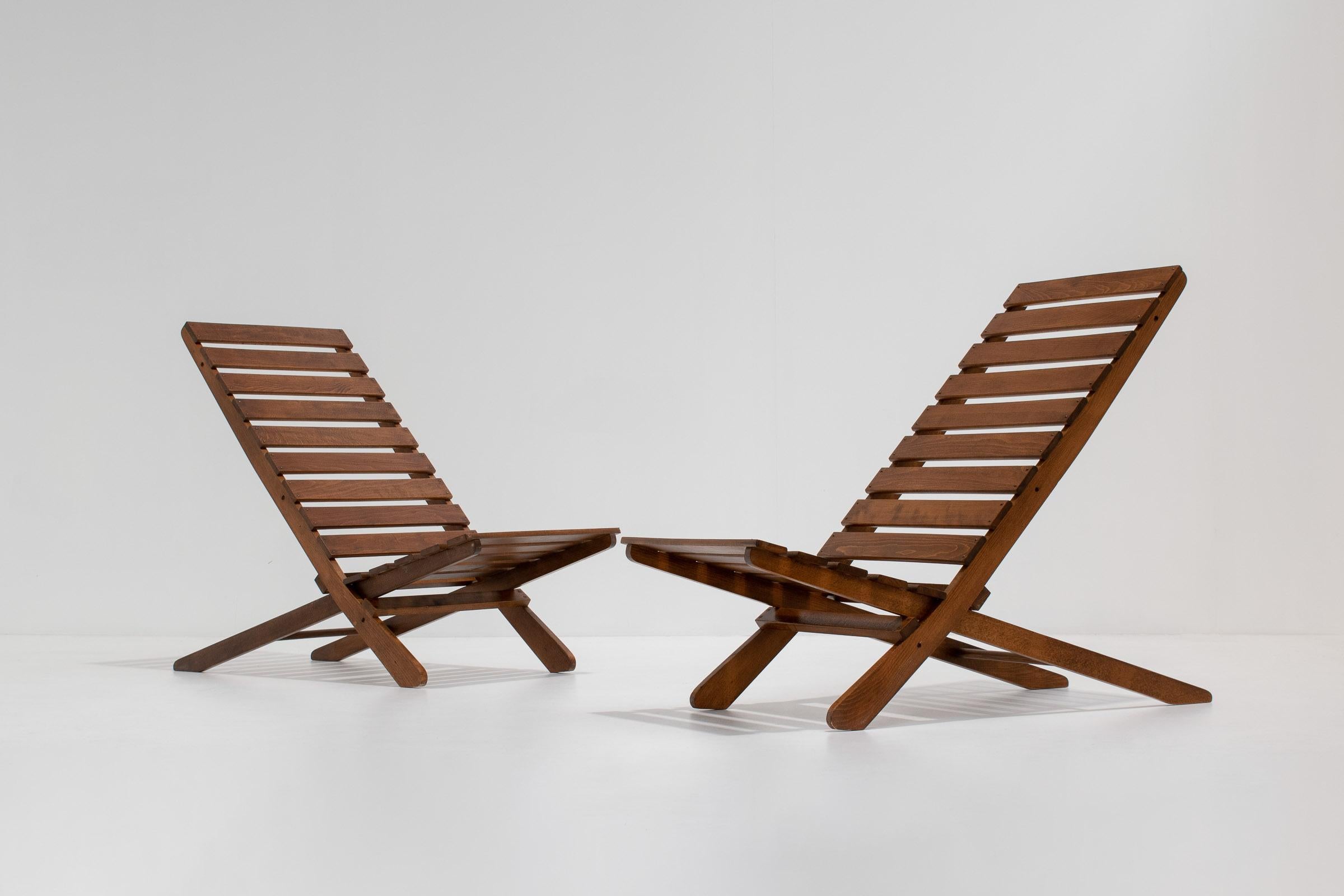 Ein wunderschönes und dekoratives Paar Scheren-Klappstühle. Dank ihres minimalistischen Designs wirken sie sehr architektonisch; die Konstruktion ist ebenso einfach wie auffällig. Die Stühle können als dekorative Beistellstühle in jedem Wohn- oder