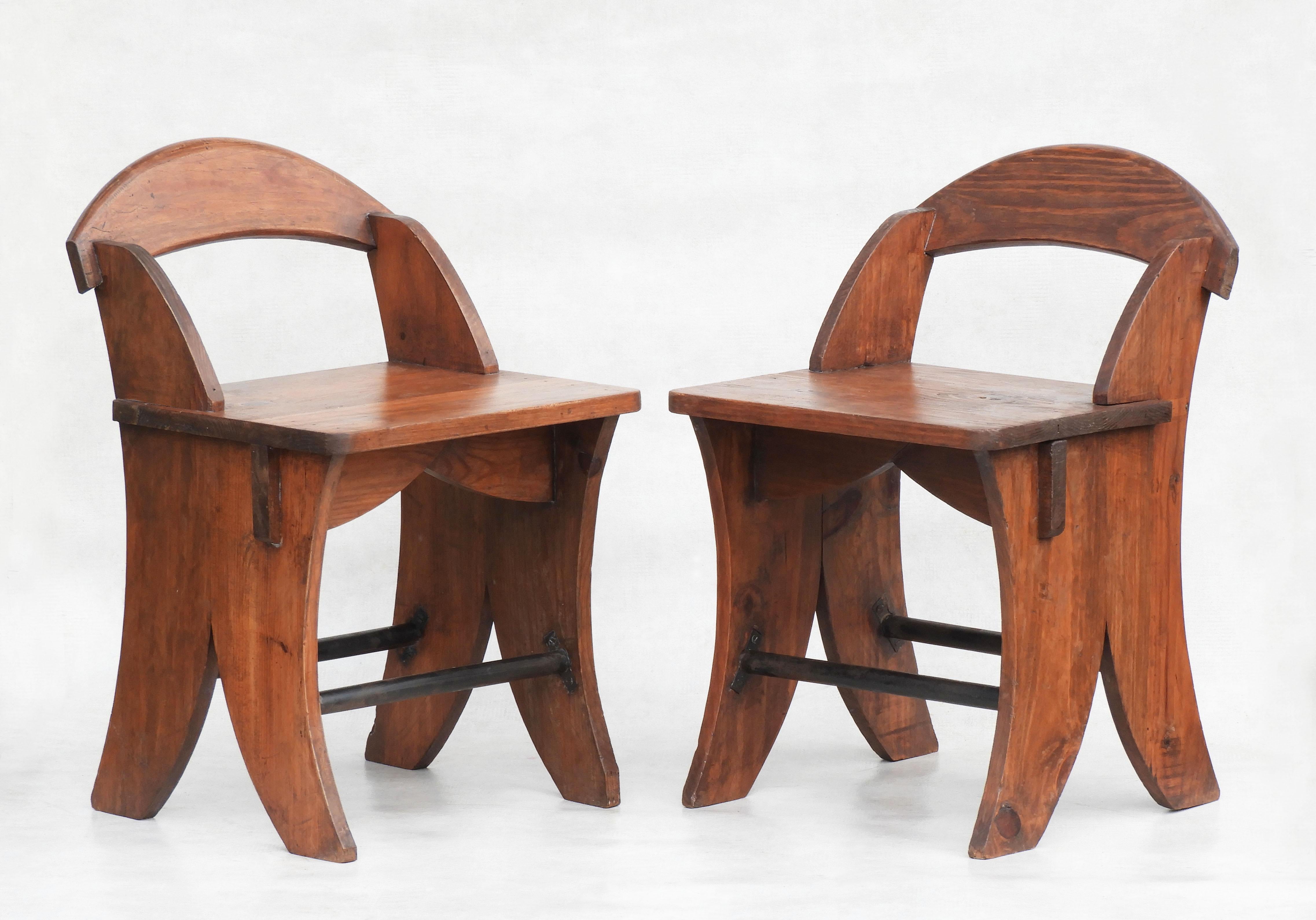 Fabulous pair of wooden Folk Art chairs from France C1930.  Unusual pine seating with curved planks on the back and legs giving off an almost 'Art Deco' vibe. This versatile duo will work as seating, side tables or even nightstands. 
Good grain with