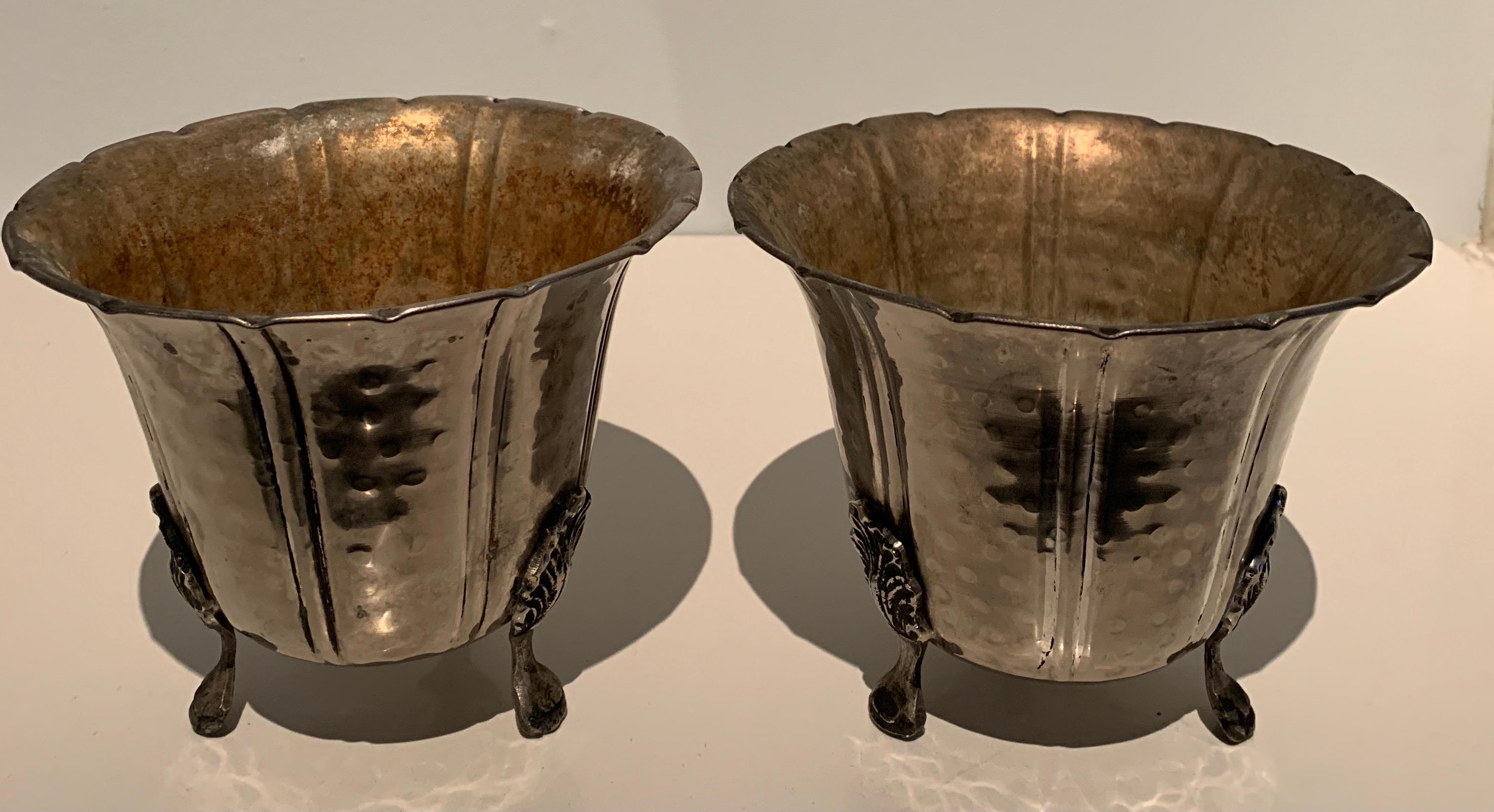A Wonderful pair of French hammered silver planters. Simple yet dynamic with lovely feet to hold them up. The pair are a compliment to any console, mantle or place, indoor or out which deserve a flanked pair. Terrific for Orchids or house